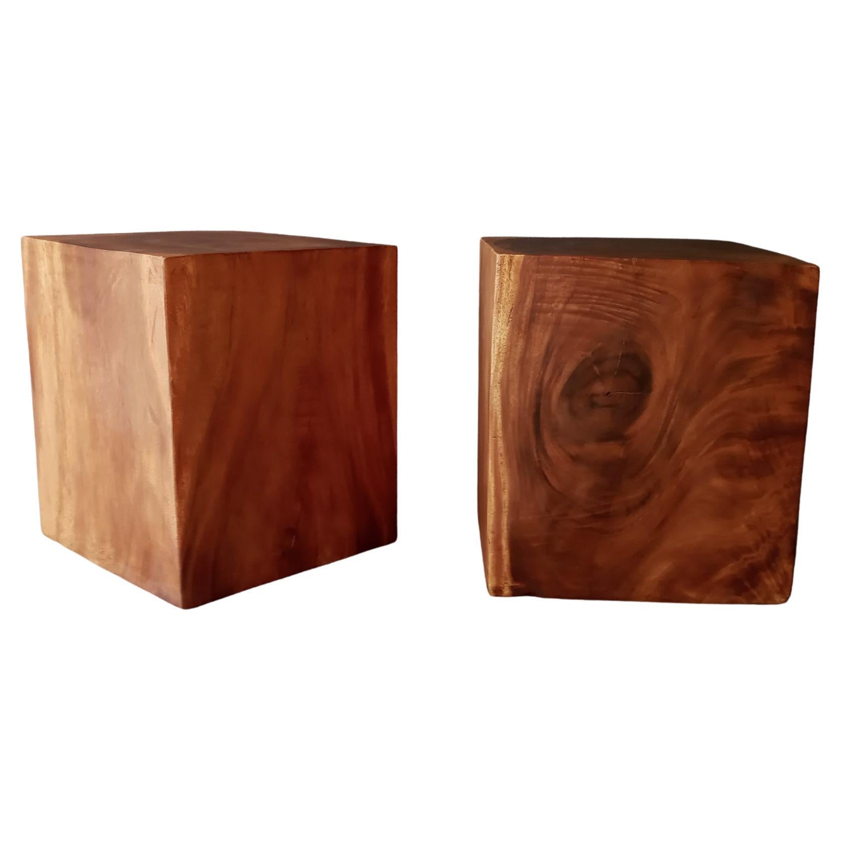 A pair of stunning solid teak cube form end or side tables. These are vintage beauties with dramatic graining and a warm patina. Each has a hollowed core but the wall are roughly 3