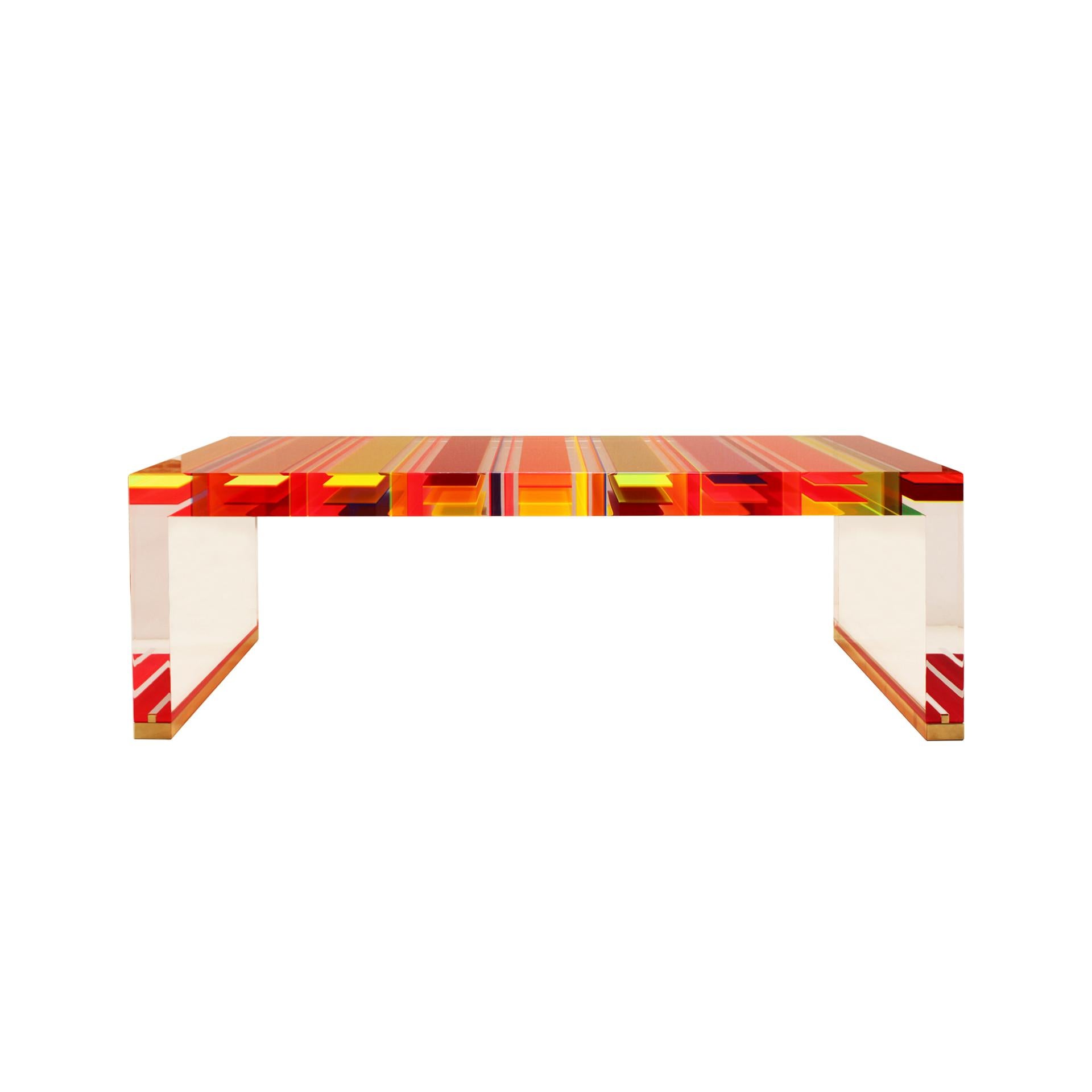 Table basse rectangulaire conçue par le Studio Superego de Milan, réalisée en plexiglas multicolore et transparent de sept centimètres d'épaisseur et dont les pieds sont finis en laiton.

Superego Studio est un studio de design basé à Milan, en