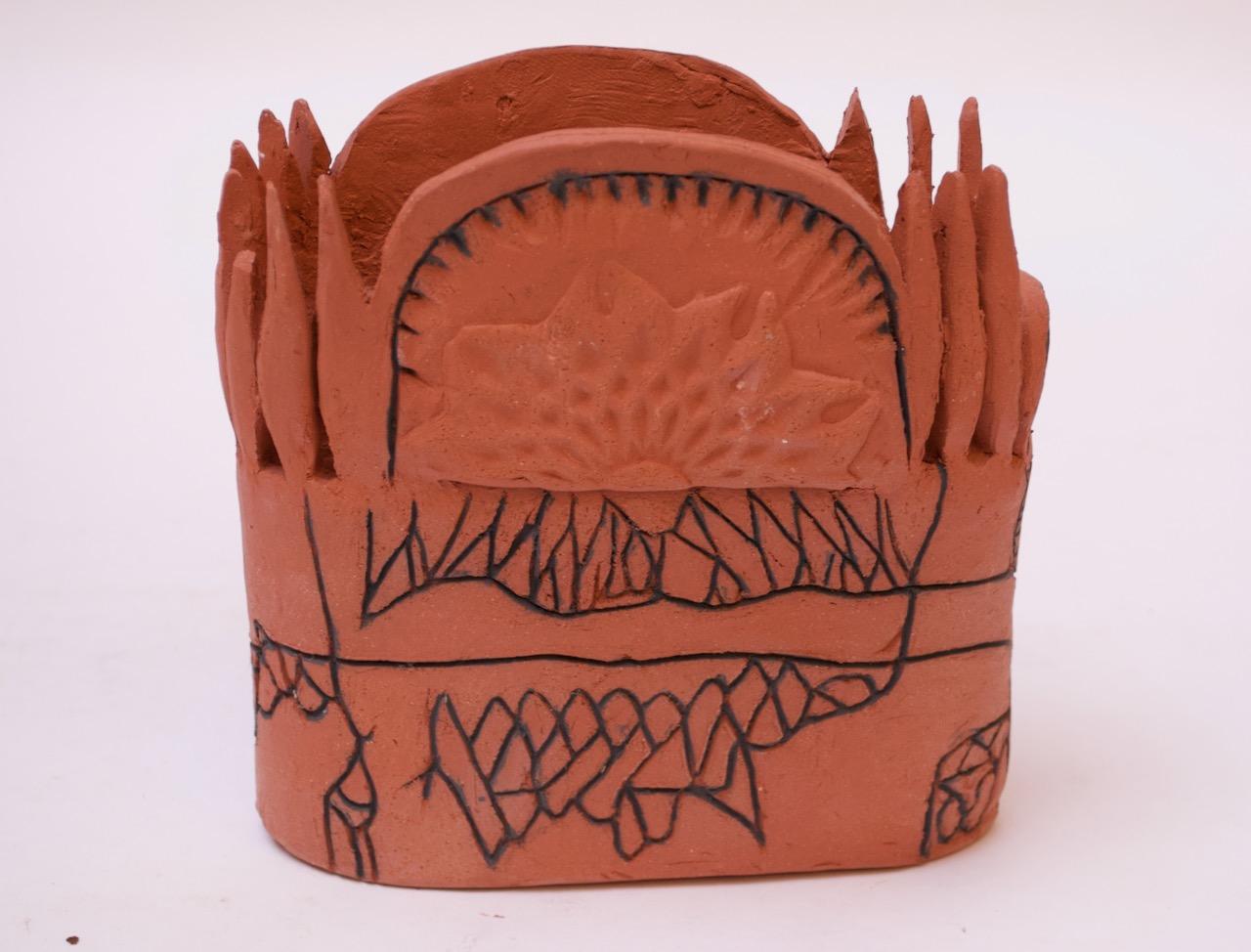 Terracotta vase with hand-drawn details with an Aztec-inspired pattern, circa 1970s USA. Molded floral central image surrounded by 