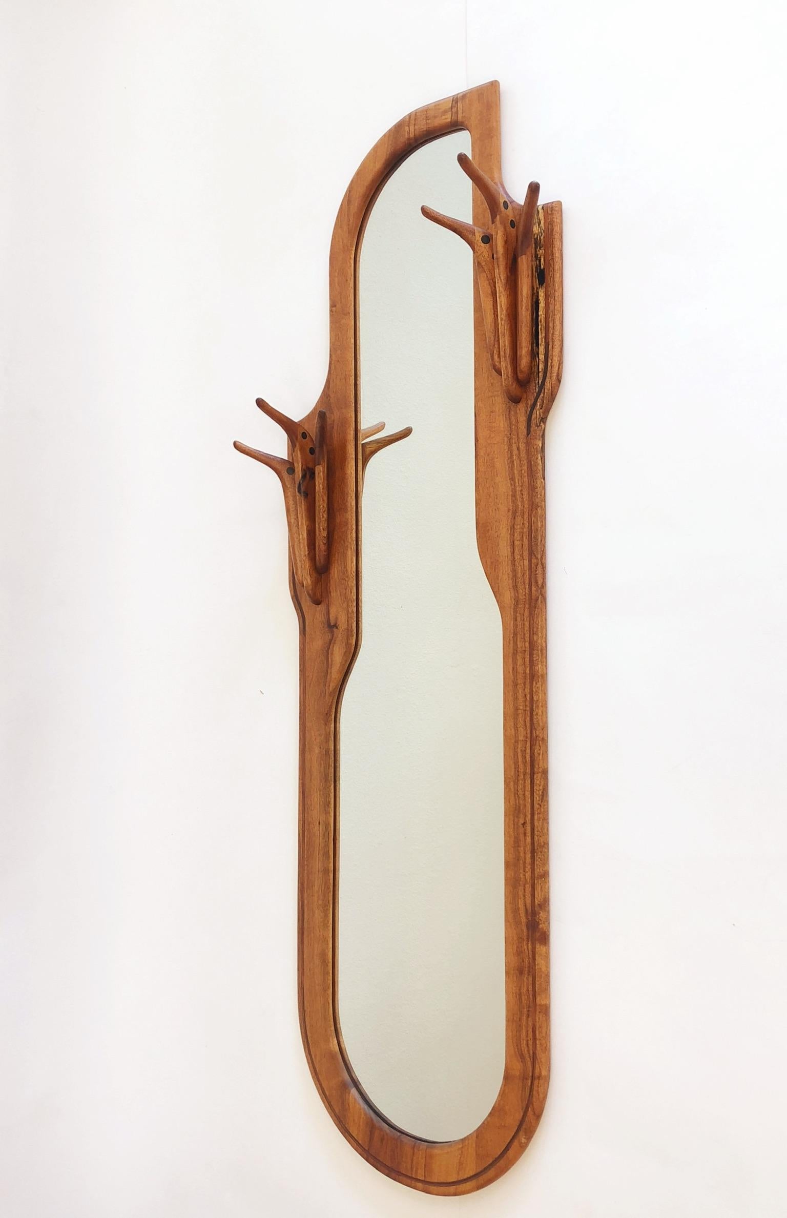 A spectacular American studio craftsman walnut mirror with a built in coat hanger. The mirror is Signed Charles B. Cobb and dated 1976.
Overall dimensions: 65” high 24” wide 6.5” deep.