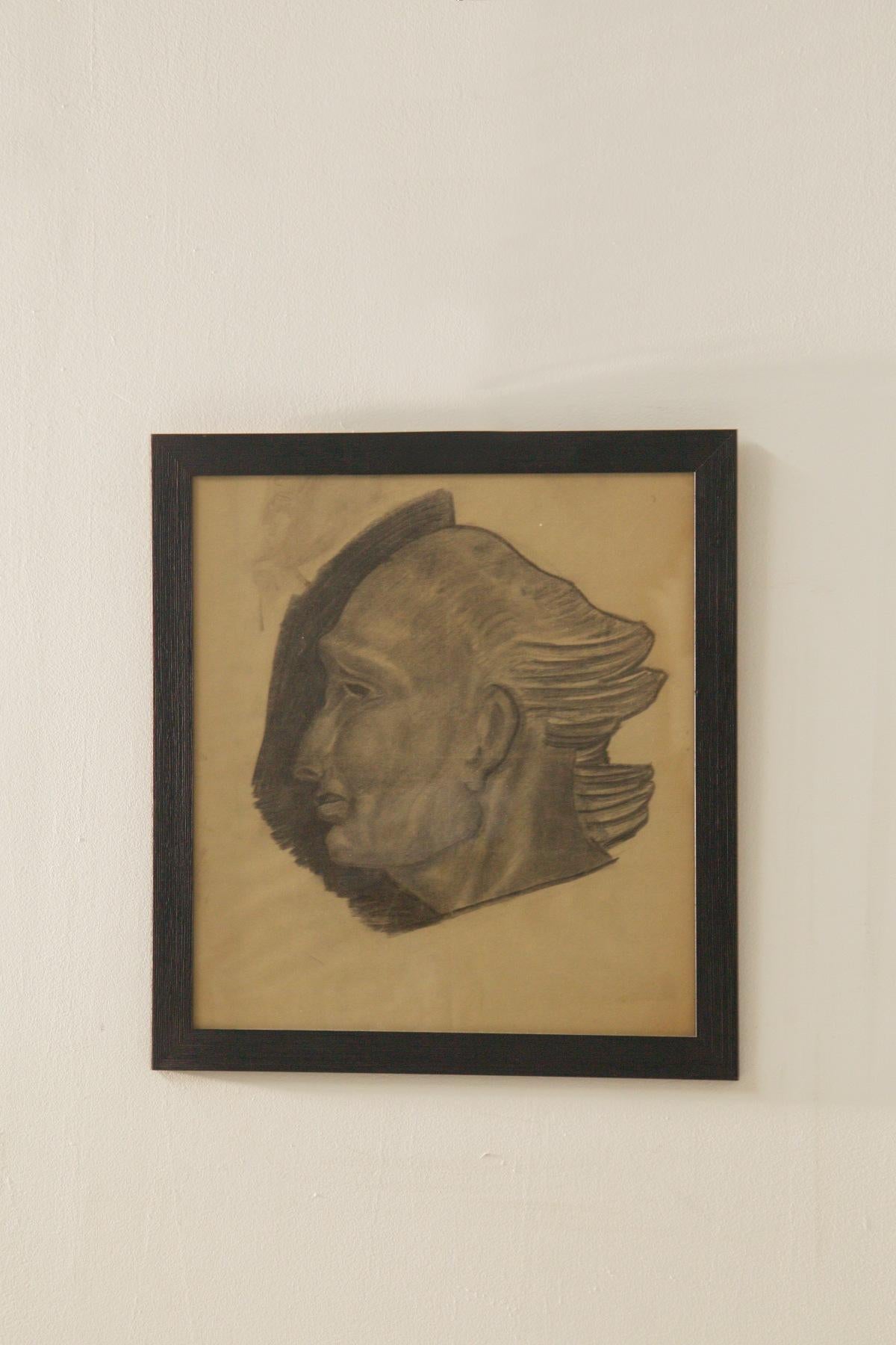Refined charcoal drawing on paper depicting a study of a male head in profile. The work is striking for the plastic force of the modeling and the skillful use of chiaroscuro, which gives the figure an intense sculptural presence. The volumetric