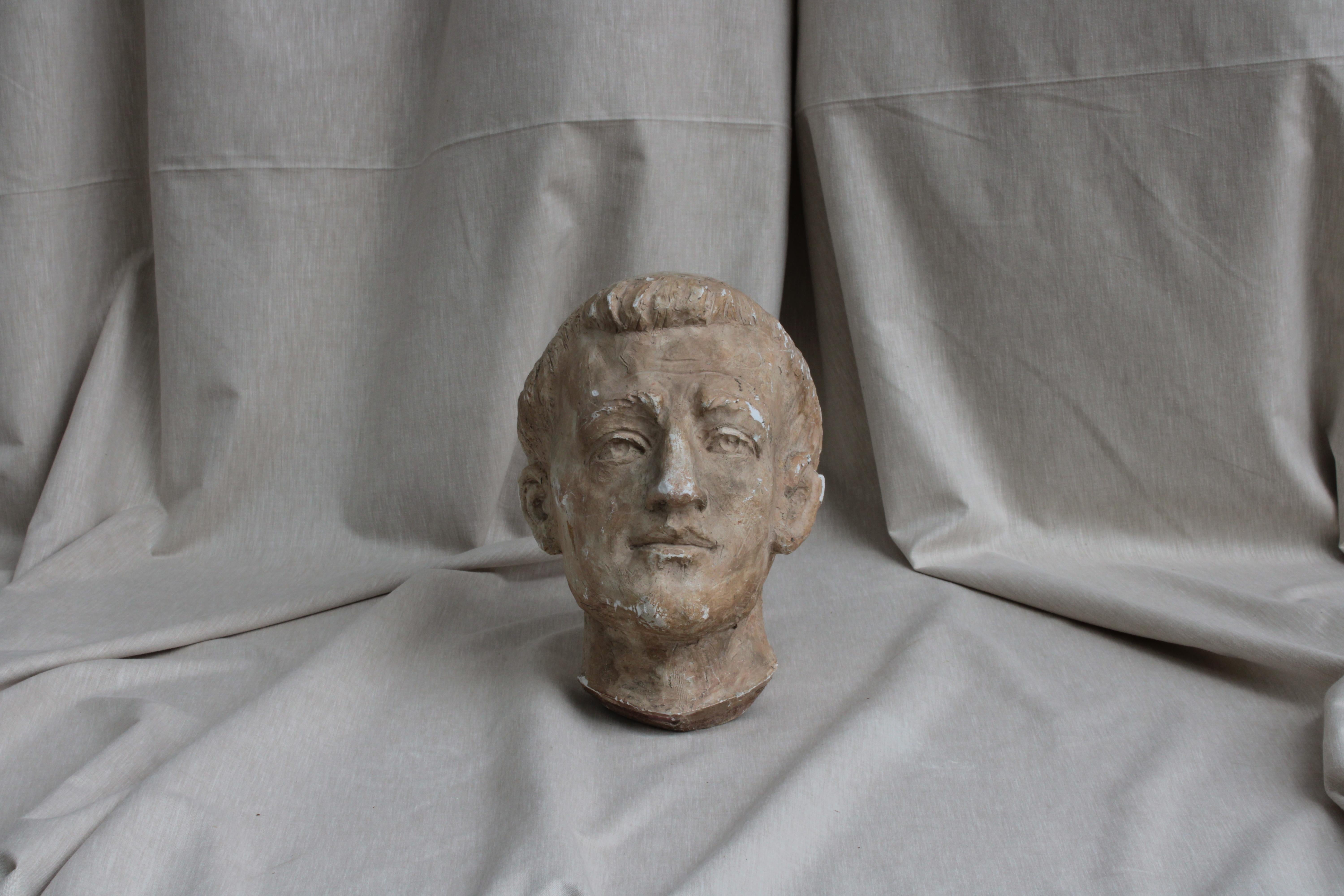 A male head study from the twentieth-century, in patinated plaster, possibly depicting a head of a friar, or a Saint.
Patinated plaster sculpture is a process in which plaster is applied and sculpted to create the desired shape, and then a patina