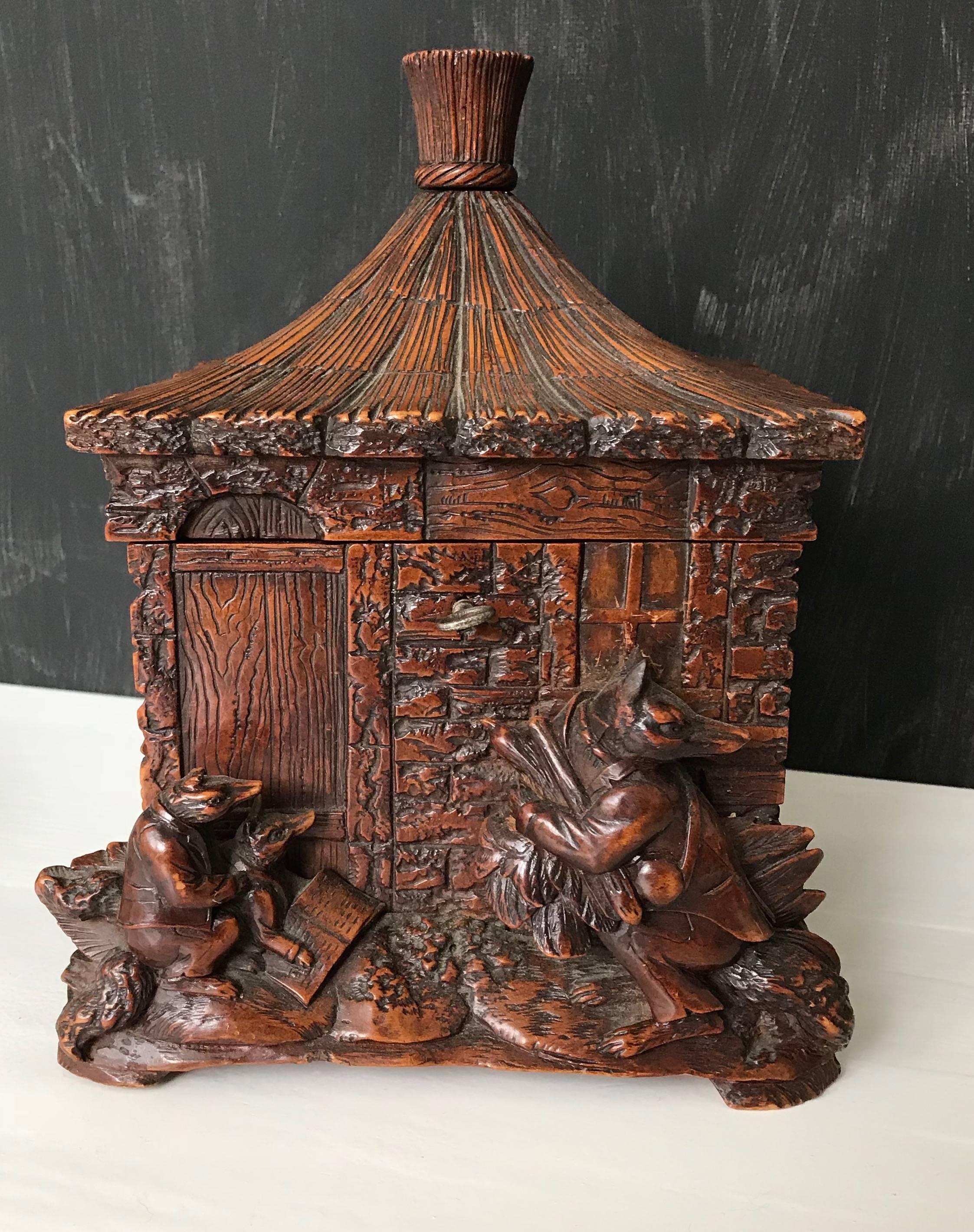 Masterly carved antique, cottage design box from circa 1870.

If you are a collector of truly magnificent Black Forest artwork then you will love this cottage shaped box with the fox family group out front. The mother fox is learning her cub to read