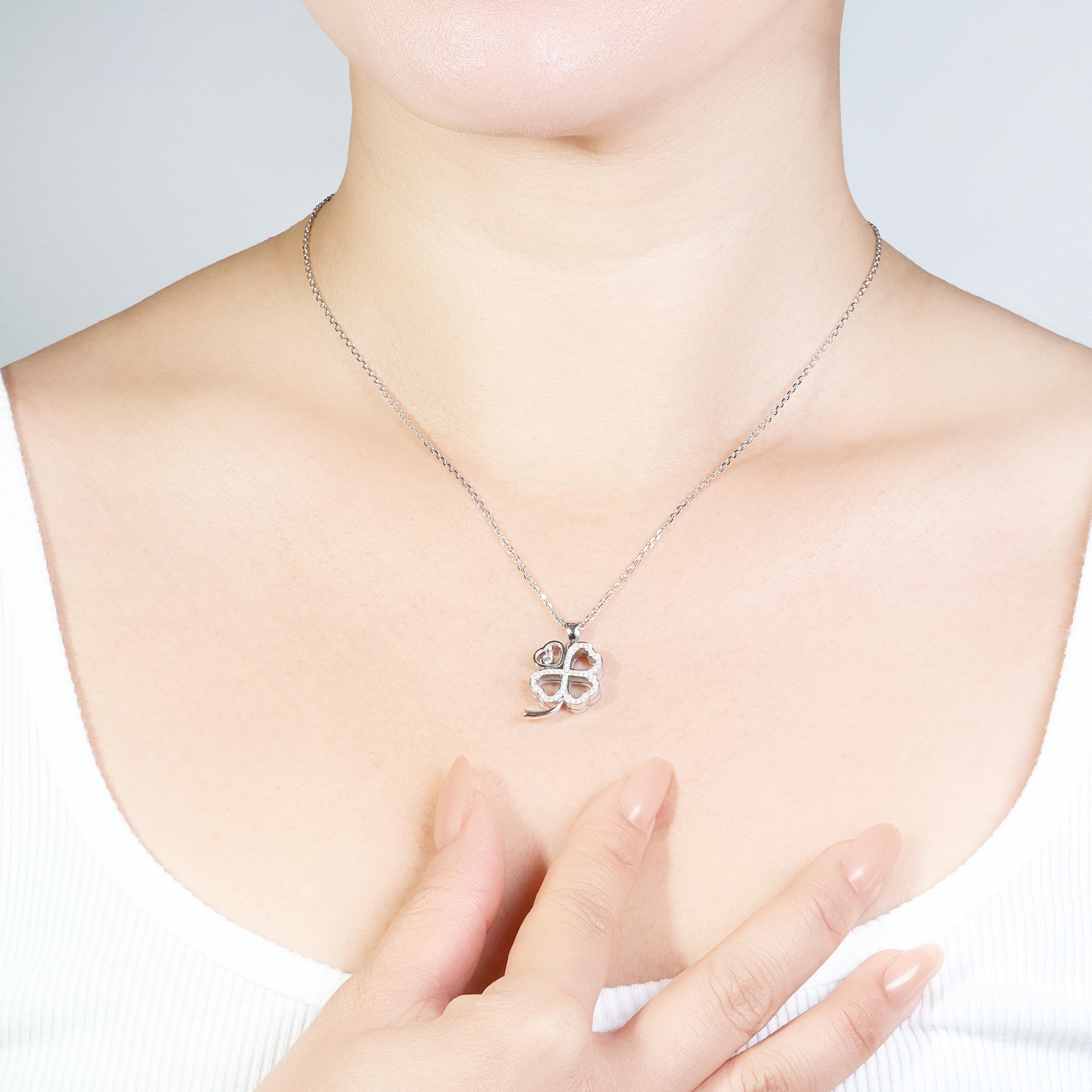 Discover the elegance of this stunning necklace, crafted from 18K white gold and adorned with a clover pendant. The main stone is a single round brilliant natural diamond weighing 0.05ct, exhibiting an F color grade and VVS clarity. Complementing it