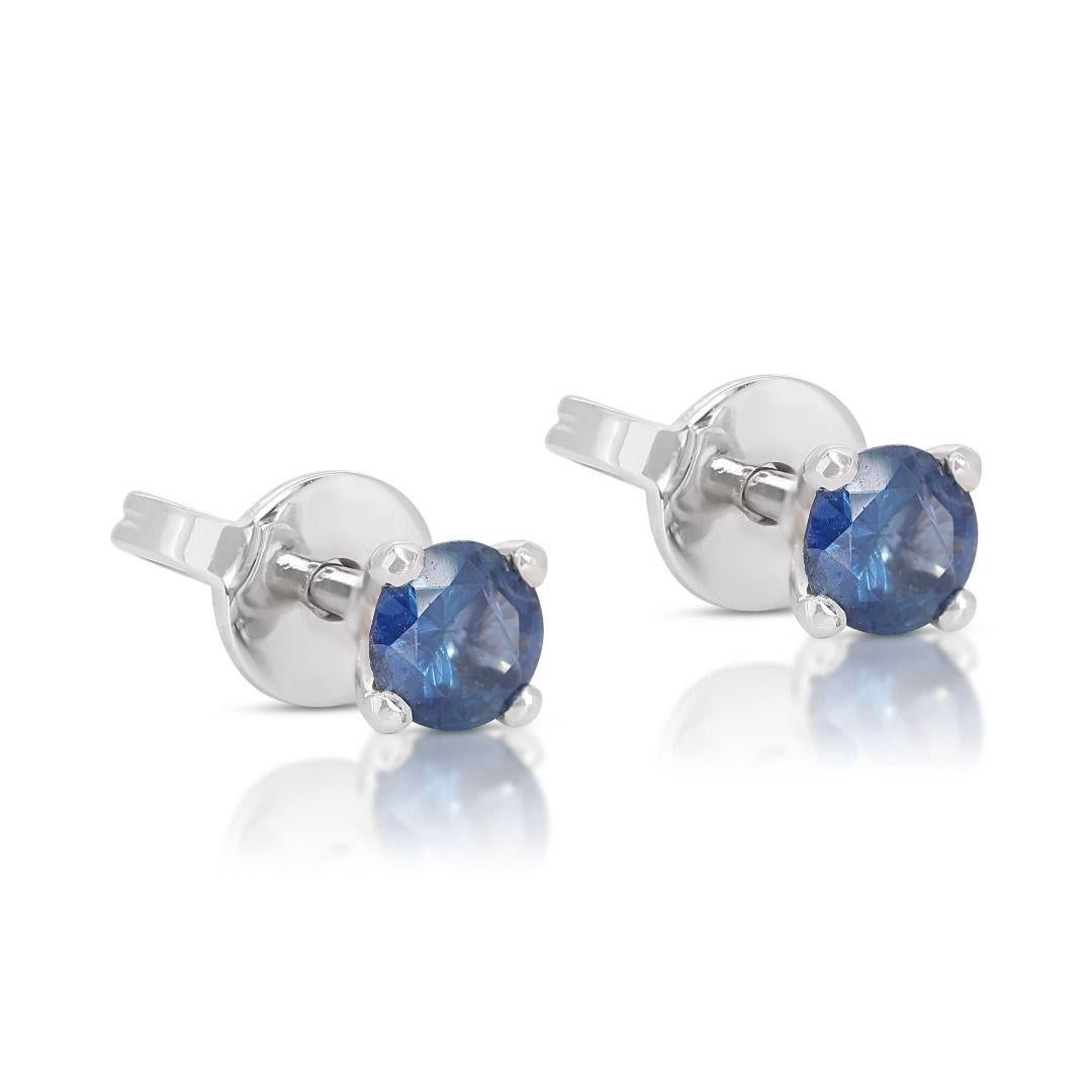 Each earring features a stunning round brilliant blue sapphire stone, totaling 0.30 carats. These captivating gemstones exhibit a mesmerizing hue of blue, radiating sophistication and grace with every glance. Crafted with precision and attention to