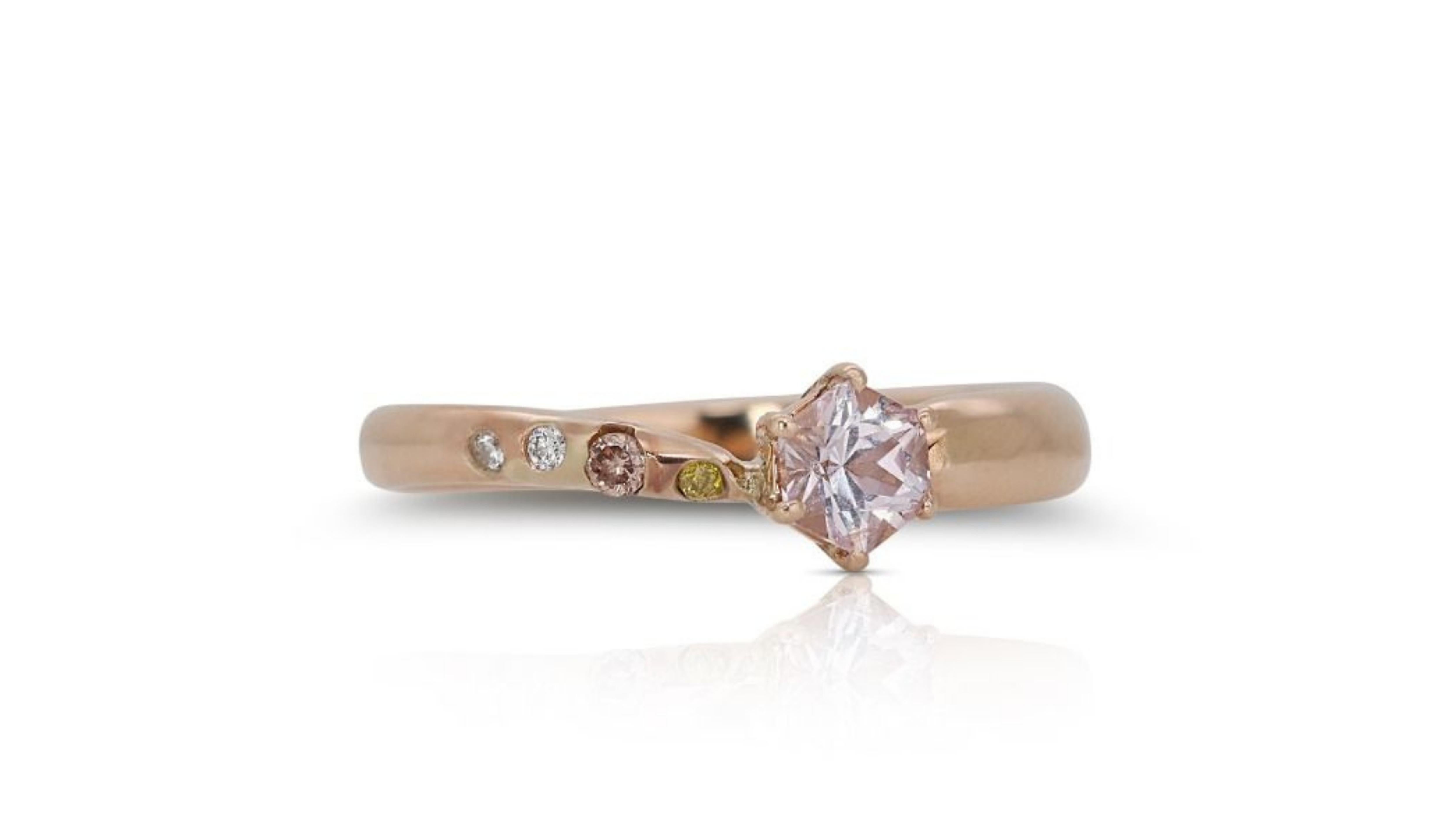 A dazzling pendant crafted from 18K rose gold, this exquisite piece features a captivating .05 carat round brilliant diamond as its centerpiece. The breathtaking main stone boasts a captivating - color and exceptional VS clarity, while a halo of