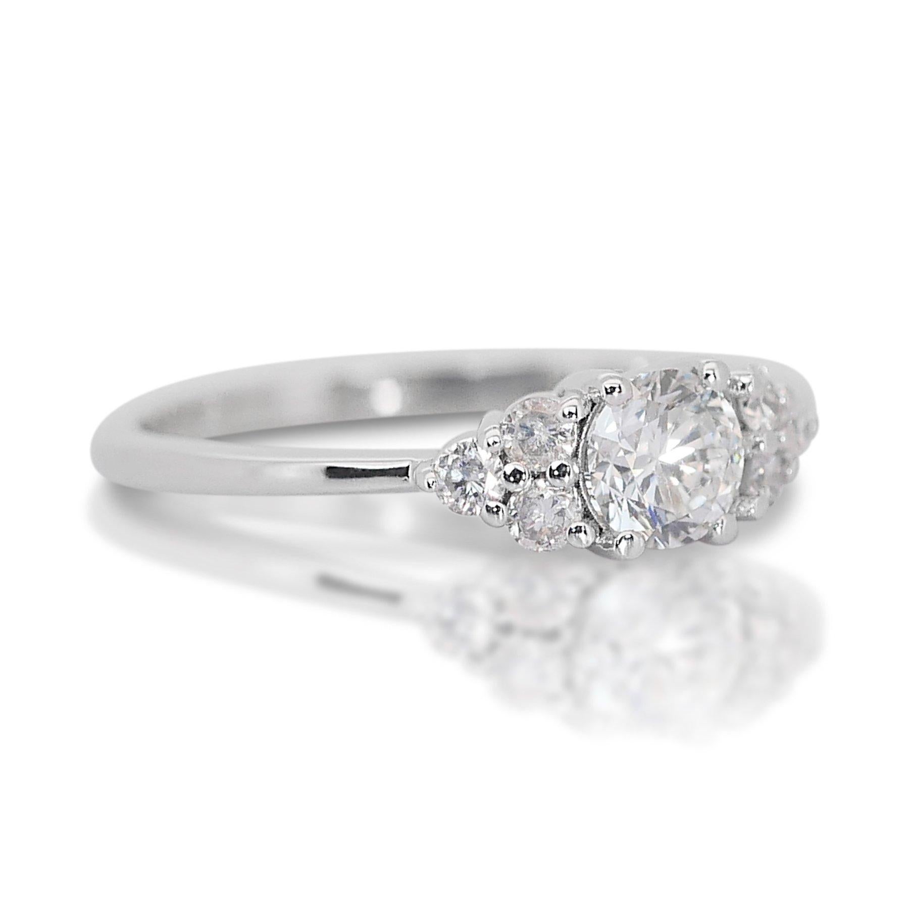 Stunning 0.70ct Triple Excellent Ideal Cut Diamond Ring in 18k White Gold - GIA Certified

Indulge in the elegance of this stunning 18k white gold ring, featuring a 0.70-carat round diamond with a triple excellent ideal cut. Complementing the main