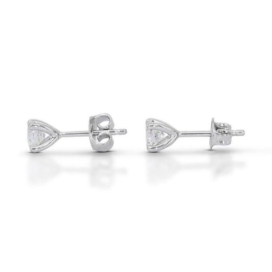Women's Stunning 0.95ct Solitaire Diamond Stud Earrings set in gleaming 18K White Gold For Sale