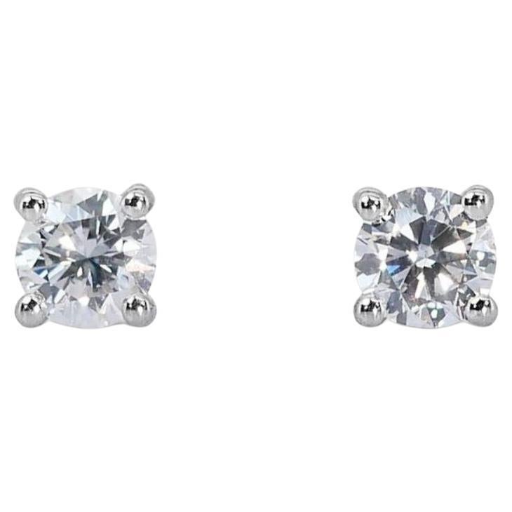 Stunning 0.95ct Solitaire Diamond Stud Earrings set in gleaming 18K White Gold For Sale