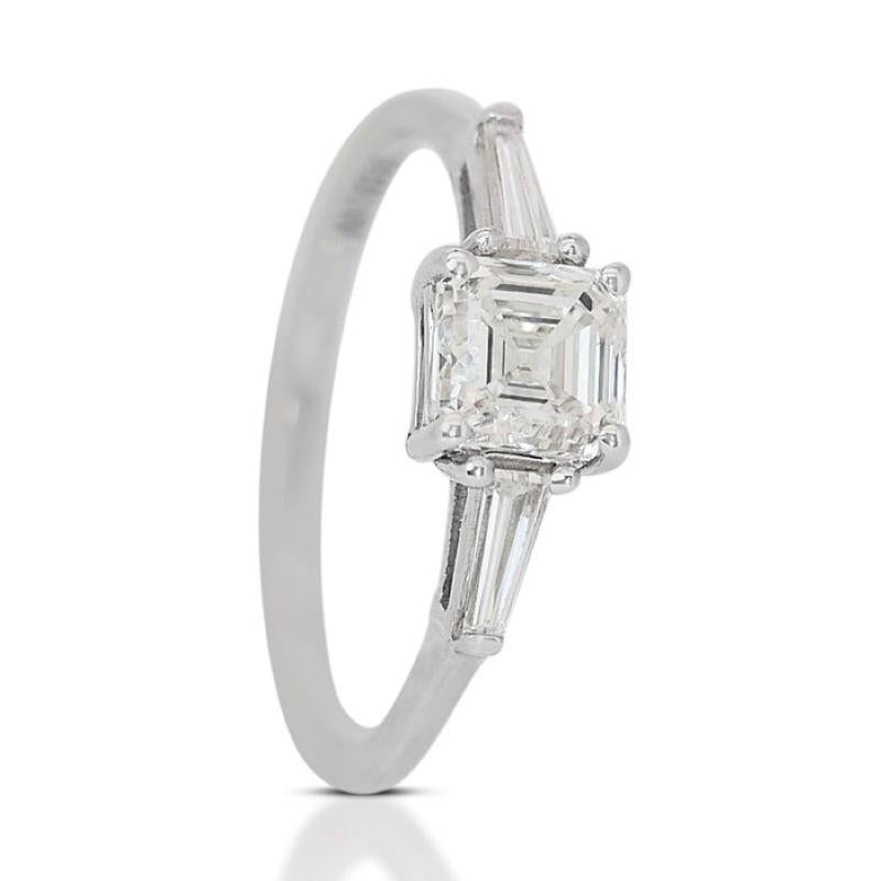 This stunning ring features a captivating square emerald-cut diamond main stone, boasting a weight of 1.00 carat. The clean lines and geometric elegance of the emerald cut accentuate the diamond's natural beauty and clarity. With a color grade