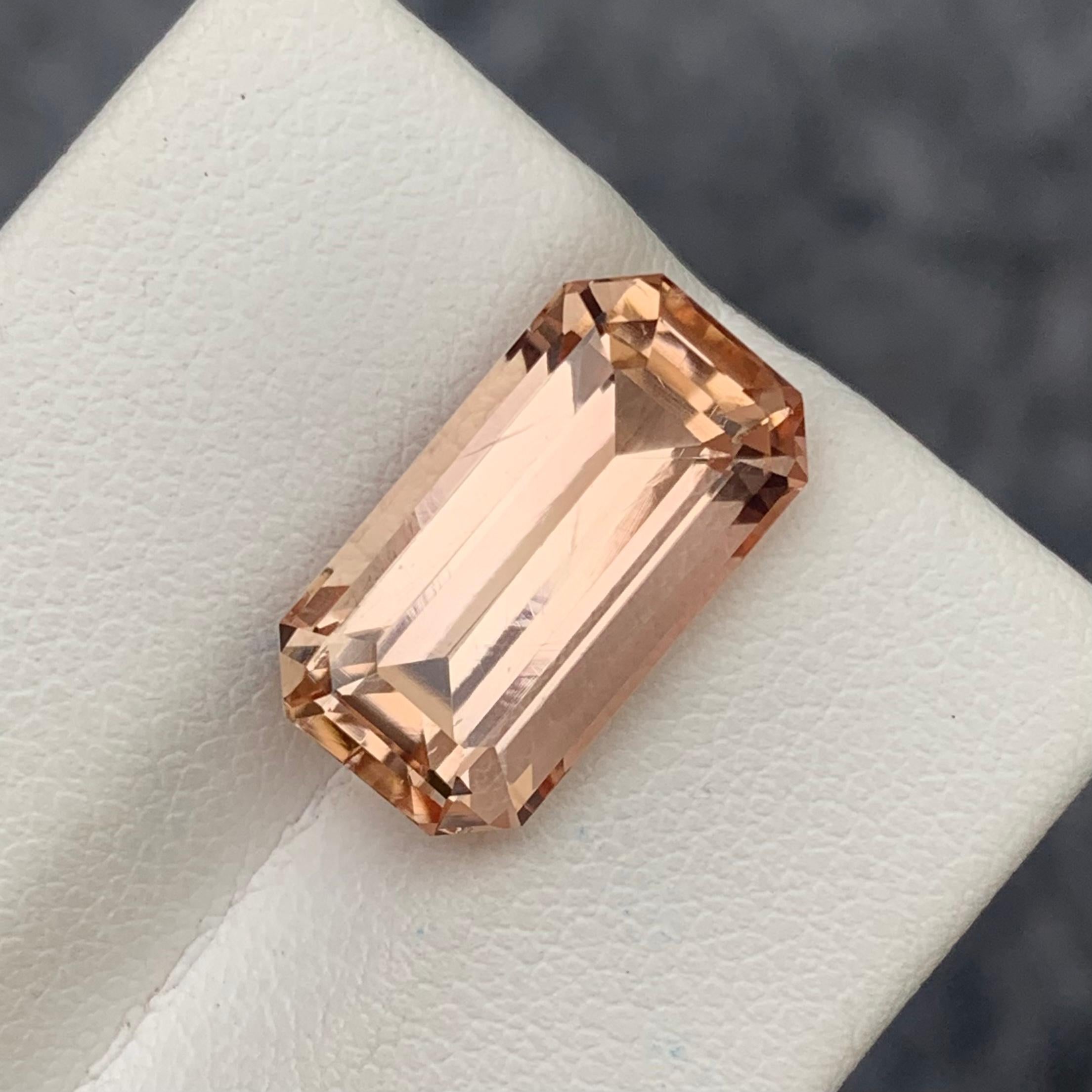 Faceted Imperial Topaz 
Weight: 10.40 Carats
Dimension: 15.9x8.6x7.8 Mm
Origin: Pakistan 
Shape: Emerald 
Color; Peach Imperial 
Treatment: Non
Certificate: On Demand 
Imperial Topaz encourages healthy boundaries and helps us be attracted to the