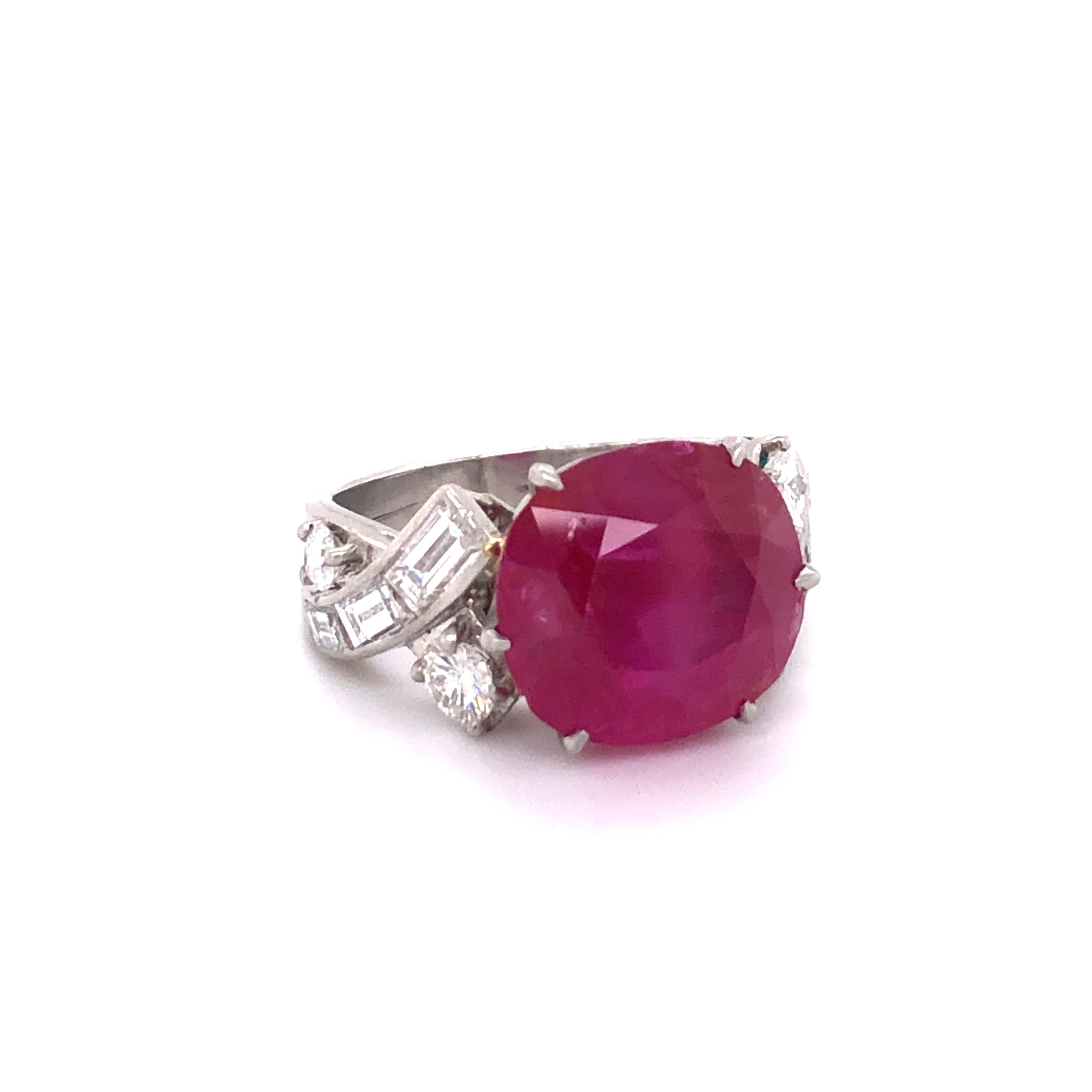 This magnificent ring in platinum is set with a cushion shaped Burma ruby of 10.40 carats. Flanked by four brililant cut diamonds and six baguette shaped diamonds of G/H color and vs clarity, total weight approximately 1.24 carats.

The ruby is