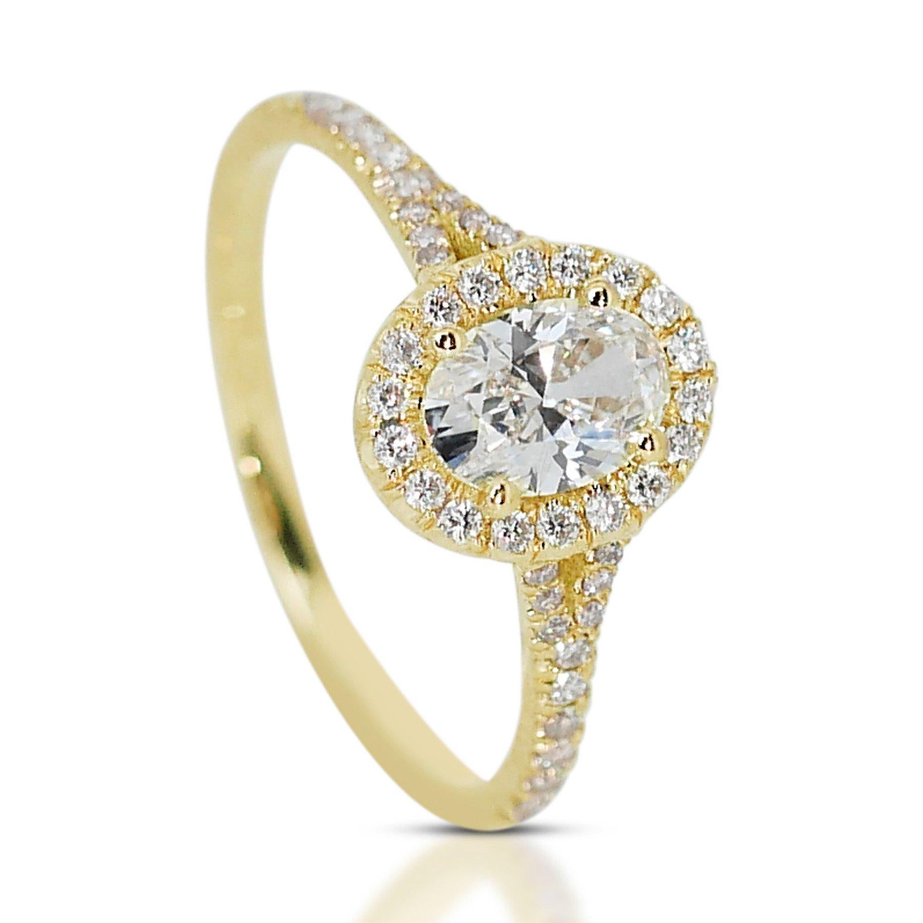 Stunning 1.05 ct Ideal Cut Oval Diamond Halo Ring with split shank  in 18k Yellow Gold – GIA Certified

Crafted in elegant 18k yellow gold, this halo ring features a captivating 0.75-carat oval diamond. Encircling the main diamond are 44 round side