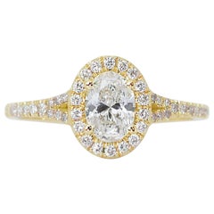 Stupendo anello aureolato con diamante ovale taglio ideale da 1,05 carati con gambo spaccato