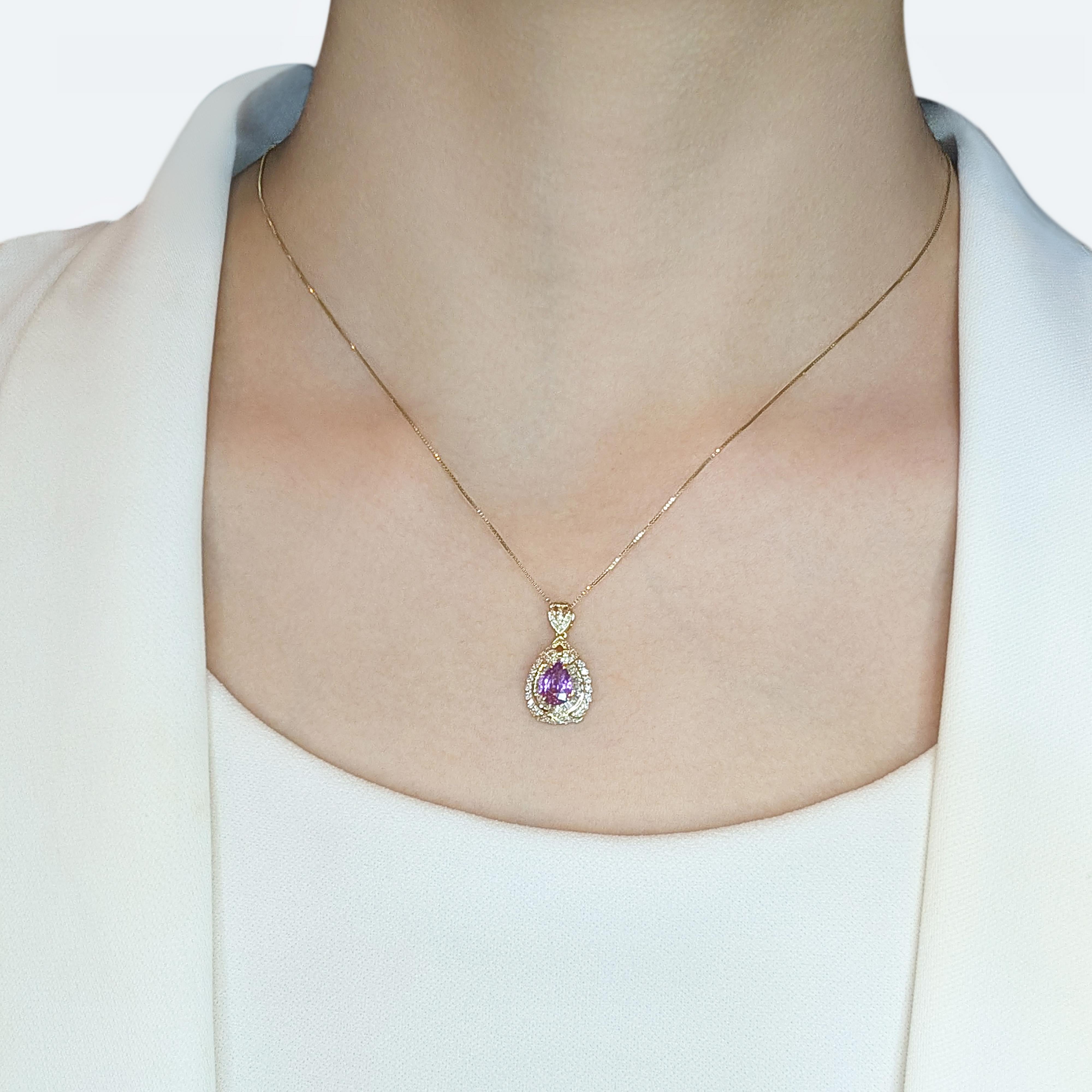 This captivating pendant is a true work of art, designed to dazzle and delight. At its heart lies a stunning 0.61ct pear-shaped purple sapphire, radiating a rare and regal charm. Surrounding the centerpiece are 18 tapered natural diamonds (0.18ct)
