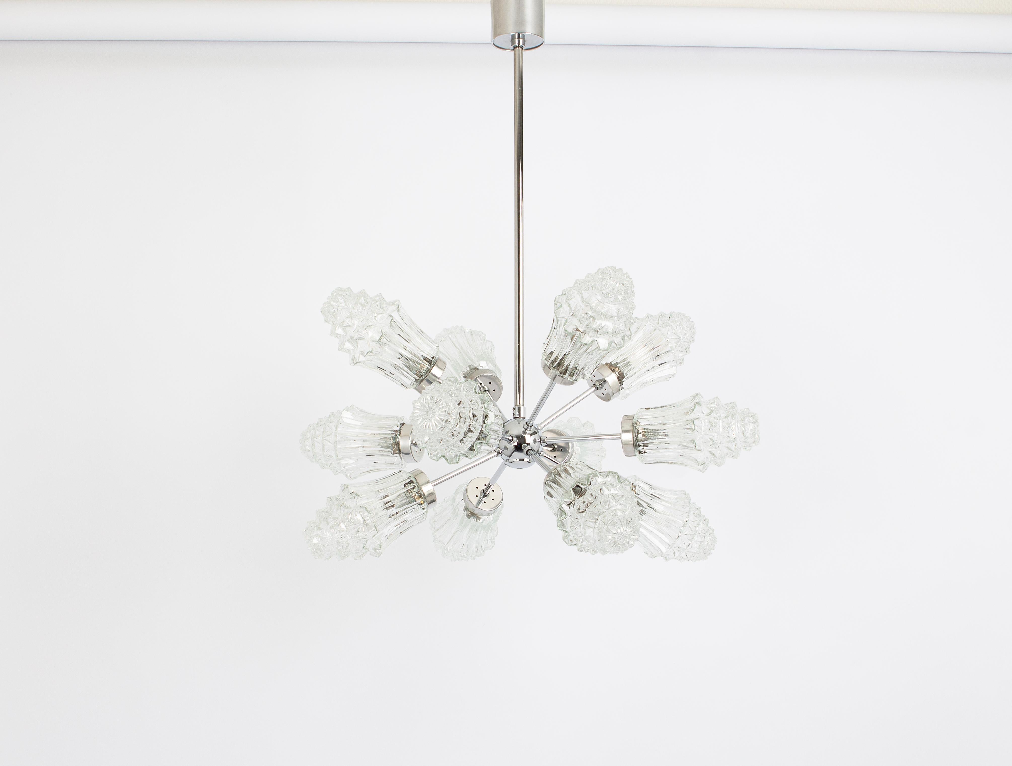 Stunning 12-arm Sputnik chandelier with 18 glass shades by Richard Essig, Germany, 1960s
Dimensions
Height
29.5 in.- (75 cm)
Diameter
25.2 in. (64 cm)
It needs 12 candelabra size bulbs up to 40 watts each.Light bulbs are not included. It is possible