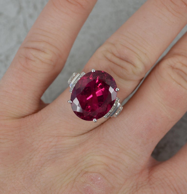 A superb Tourmaline and Diamond statement ring.
Solid 14 carat white gold example.
Designed with a large, natural, oval cut pink tourmaline to centre in four claw setting. 13.4mm x 16.4mm approx 12.5 carats. A very intense colour. Set with four