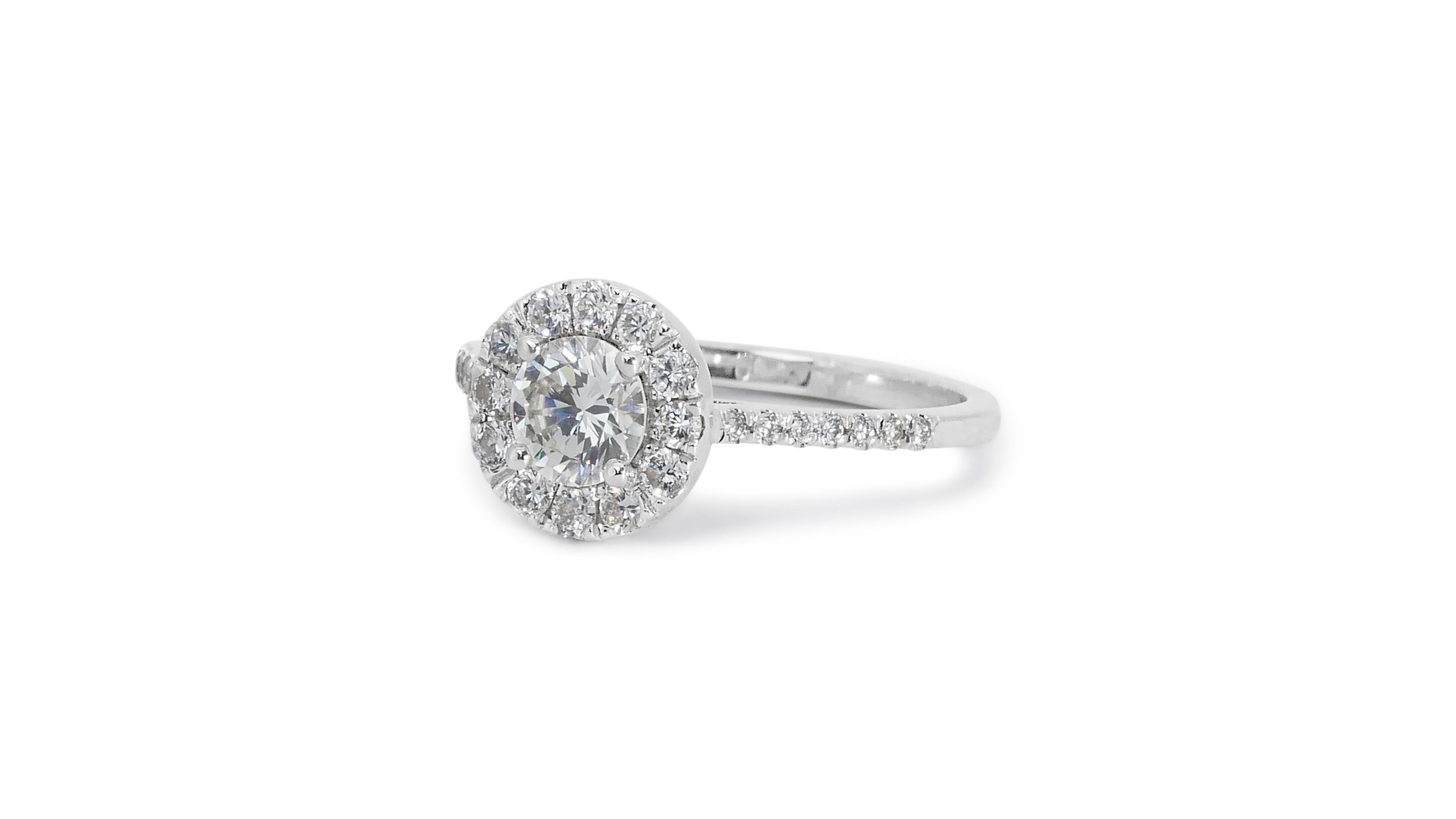 Stunning 1.35ct Diamond Halo Ring in 18k White Gold - GIA Certified

This dazzling diamond halo ring exudes timeless elegance, featuring a captivating 1.05-carat round brilliant diamond at its center. Surrounding the main stone, are 26 finely cut
