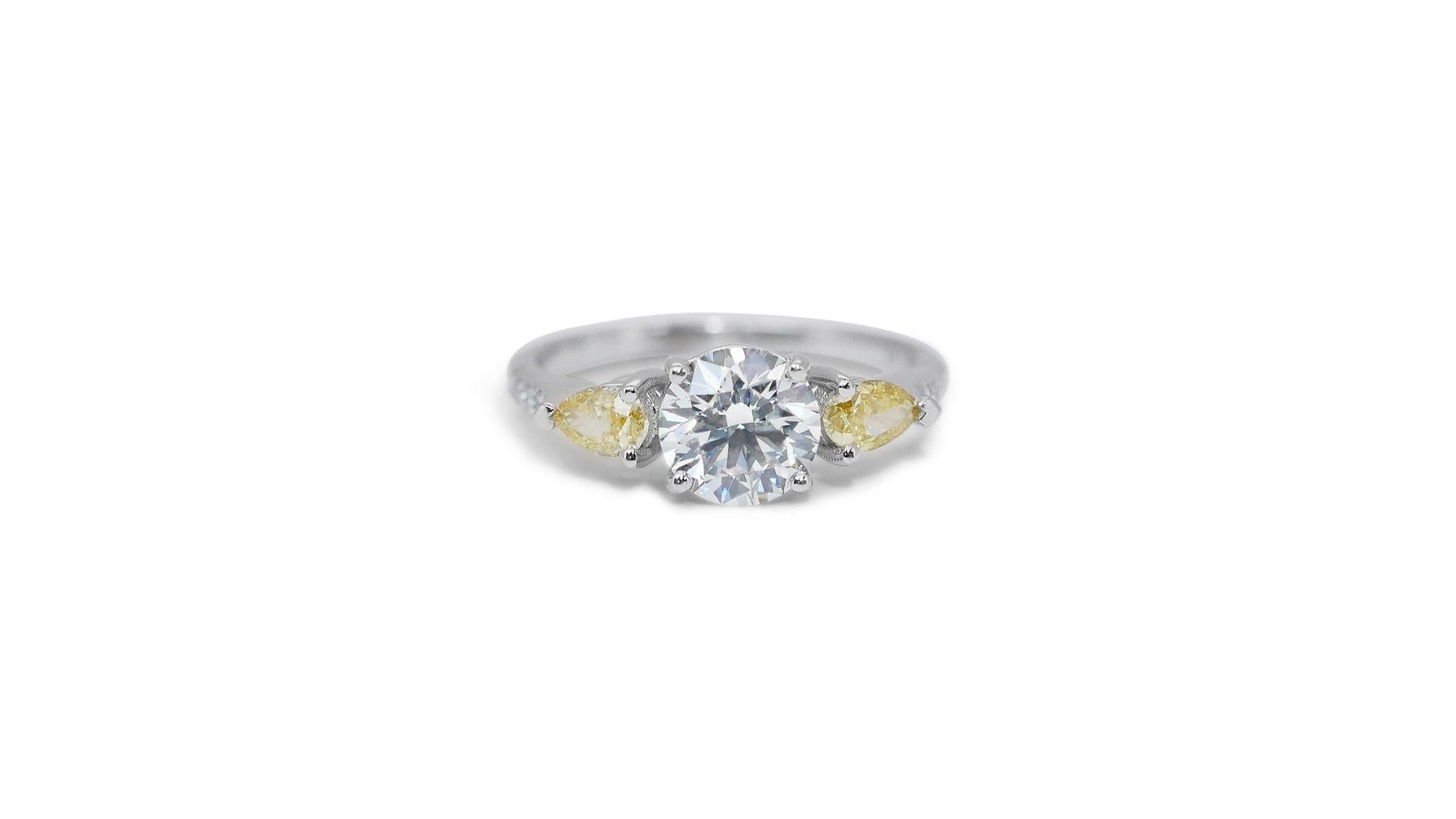 Stunning 1.37 Carat Round Brilliant Natural Diamond Ring with 0.46 Carat Fancy Intense Yellow Pear Mixed Cut and 0.065 Carat Colorless Round Brilliant Side Stones in 18K White Gold with IGI Certificate (R-1597)

This stunning diamond ring features a