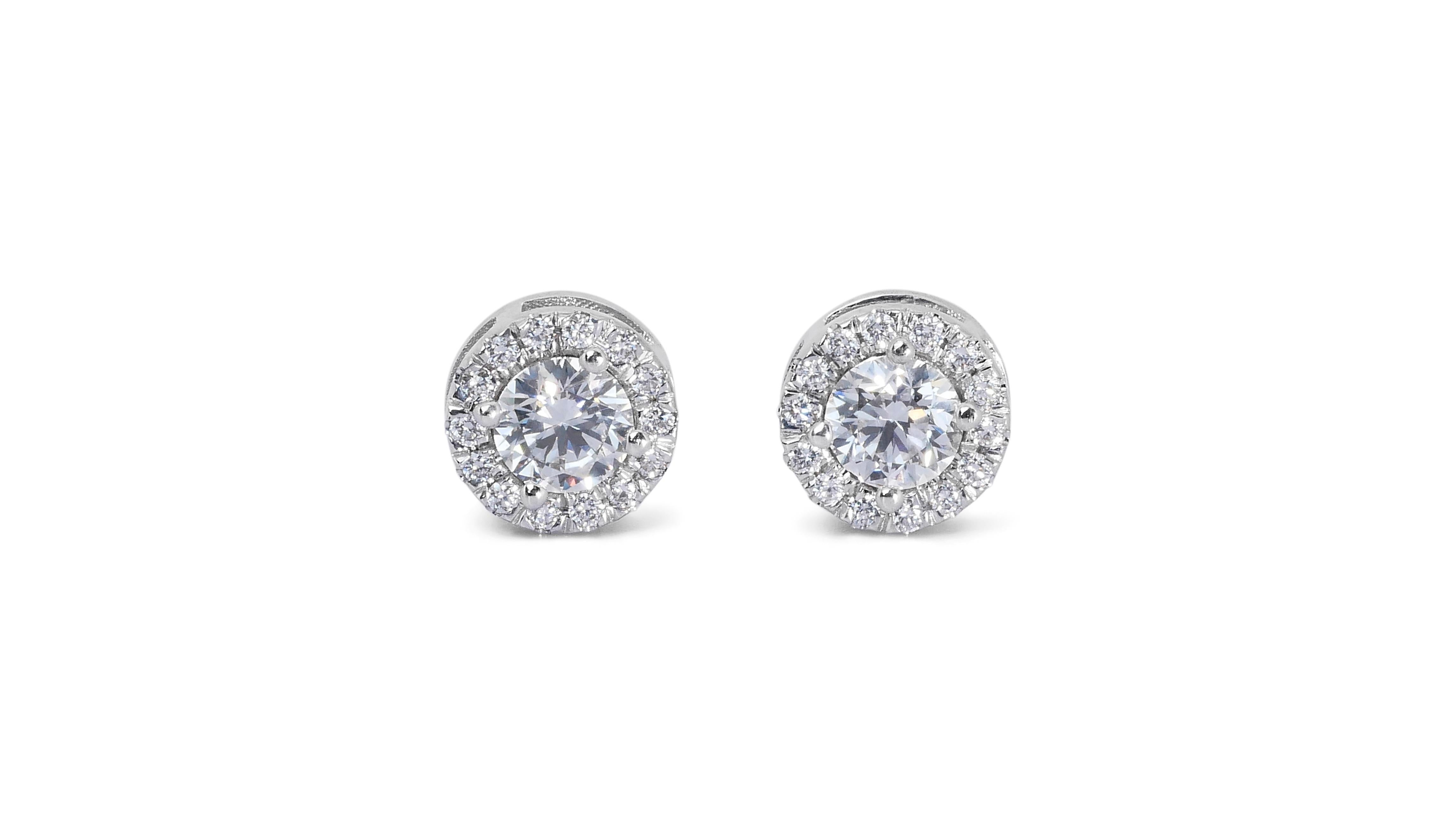 Stunning 1.37ct Triple Excellent Ideal Cut Diamonds Halo Stud Earrings in 18k White Gold  - GIA Certified

Adorn yourself with these exquisite diamond earrings, featuring two perfectly matched round diamonds, each weighing 1.12-carat. These