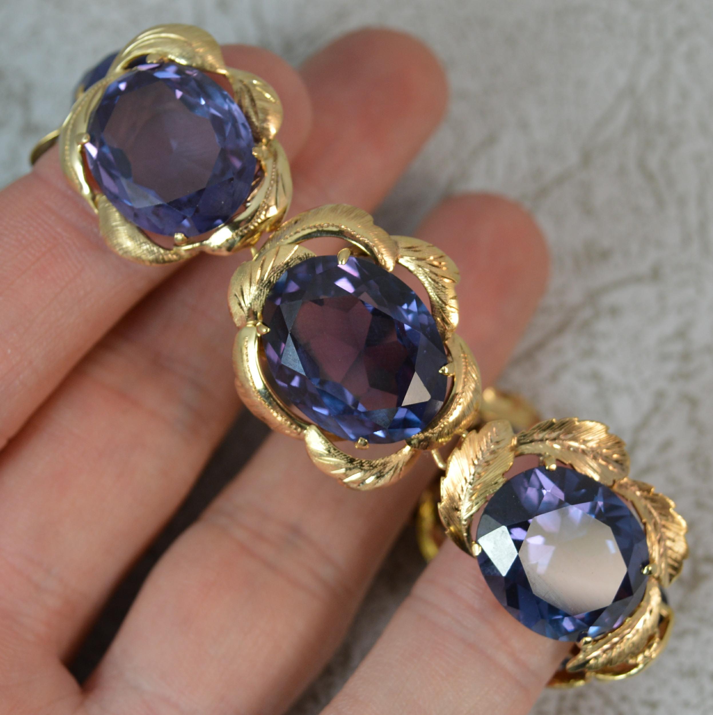 A superb vintage bracelet, circa 1950.
Modelled in 14 carat yellow gold.
Designed with seven oval cut alexandrite stones, wonderful lilac purple colour. Set in four claw mounts.
Gold leaf style surround. Some with full border, others with part.