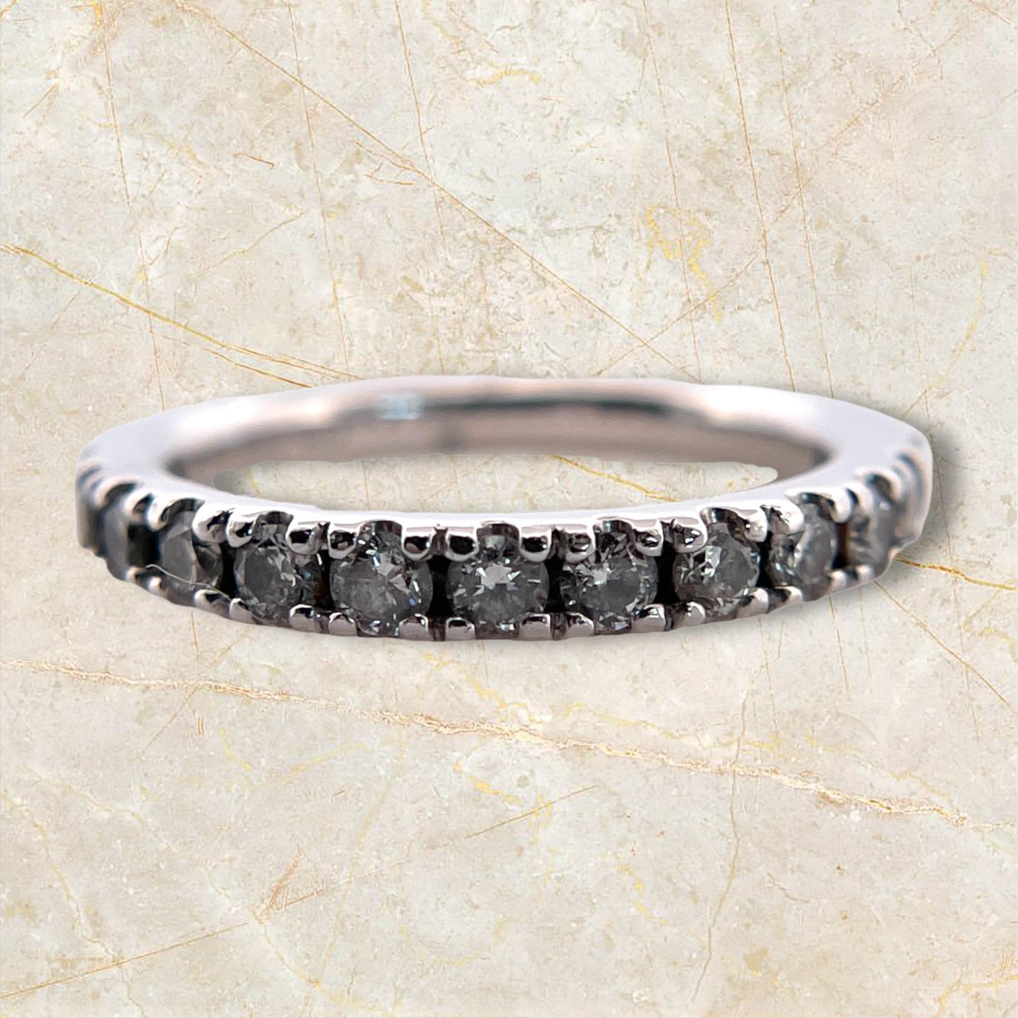 Exude timeless elegance with this 14K White Gold Diamond Band. This sophisticated ring features a continuous row of dazzling diamonds, set in lustrous white gold. Perfect as a wedding band, anniversary ring, or a stunning accessory to elevate any
