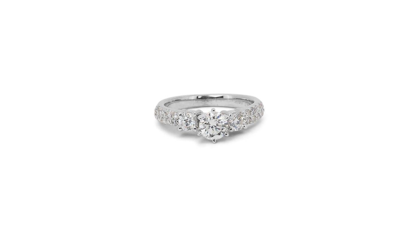 A beautiful Ring with a dazzling 0.5 carat Round Brilliant natural Diamond. It has 0.5 carat of side diamonds which add more to its elegance. The jewelry is made of 14K White Gold with a high quality polish. It comes with IGI certificate and a fancy