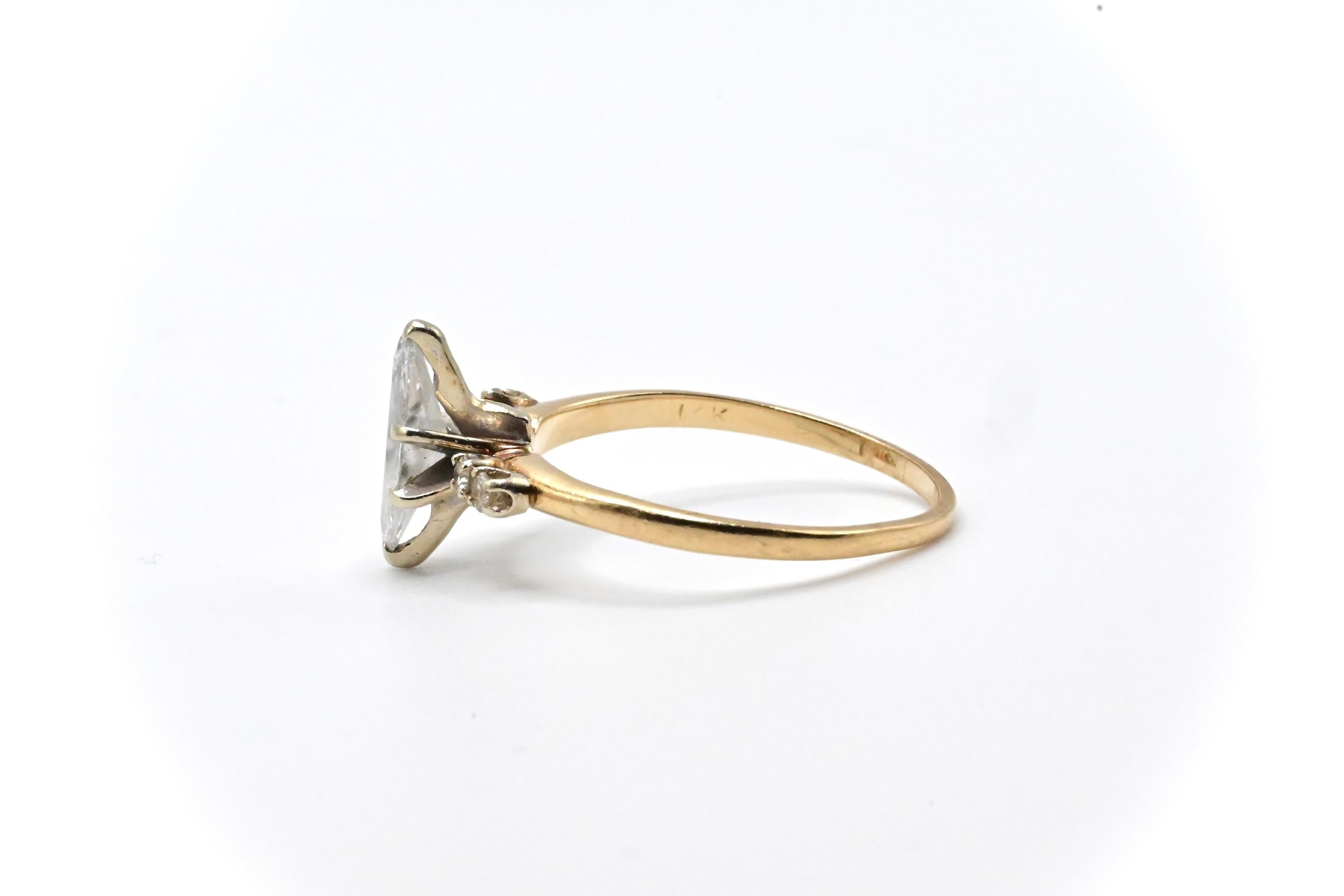This is a delightful ring made with 14k yellow gold, and a stunning marquise cut diamond centerpiece with two round cut diamonds complementing it on each side. It’s perfect for someone who’s looking for something elegant, yet simple in looks.