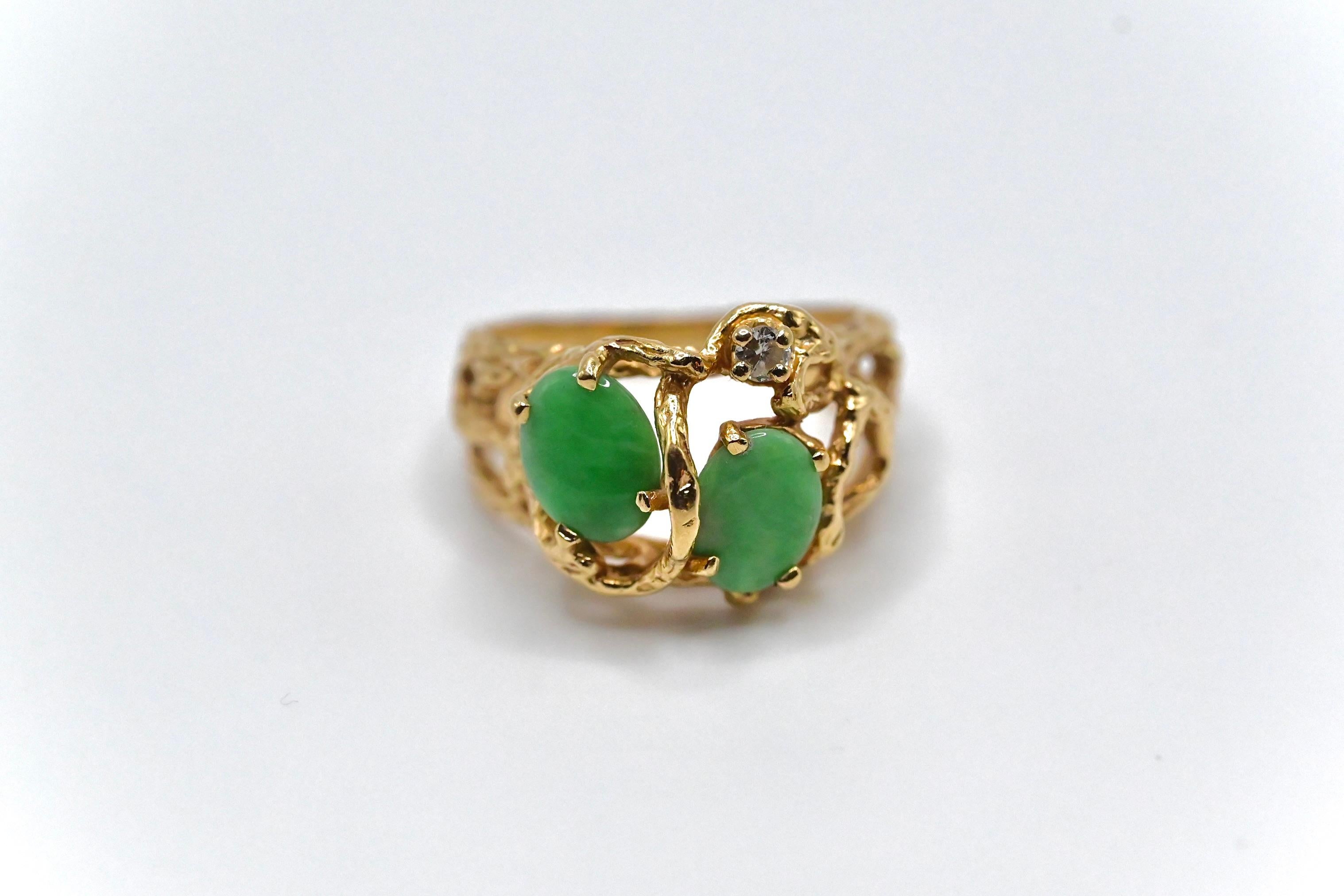 This is a unique 14K yellow gold ring made with oval shaped high quality jade, and a single fine diamond all abstractly placed. The ring is a size 7, and weighs about 5 grams. It’s in beautiful condition with little wear, and if you have any