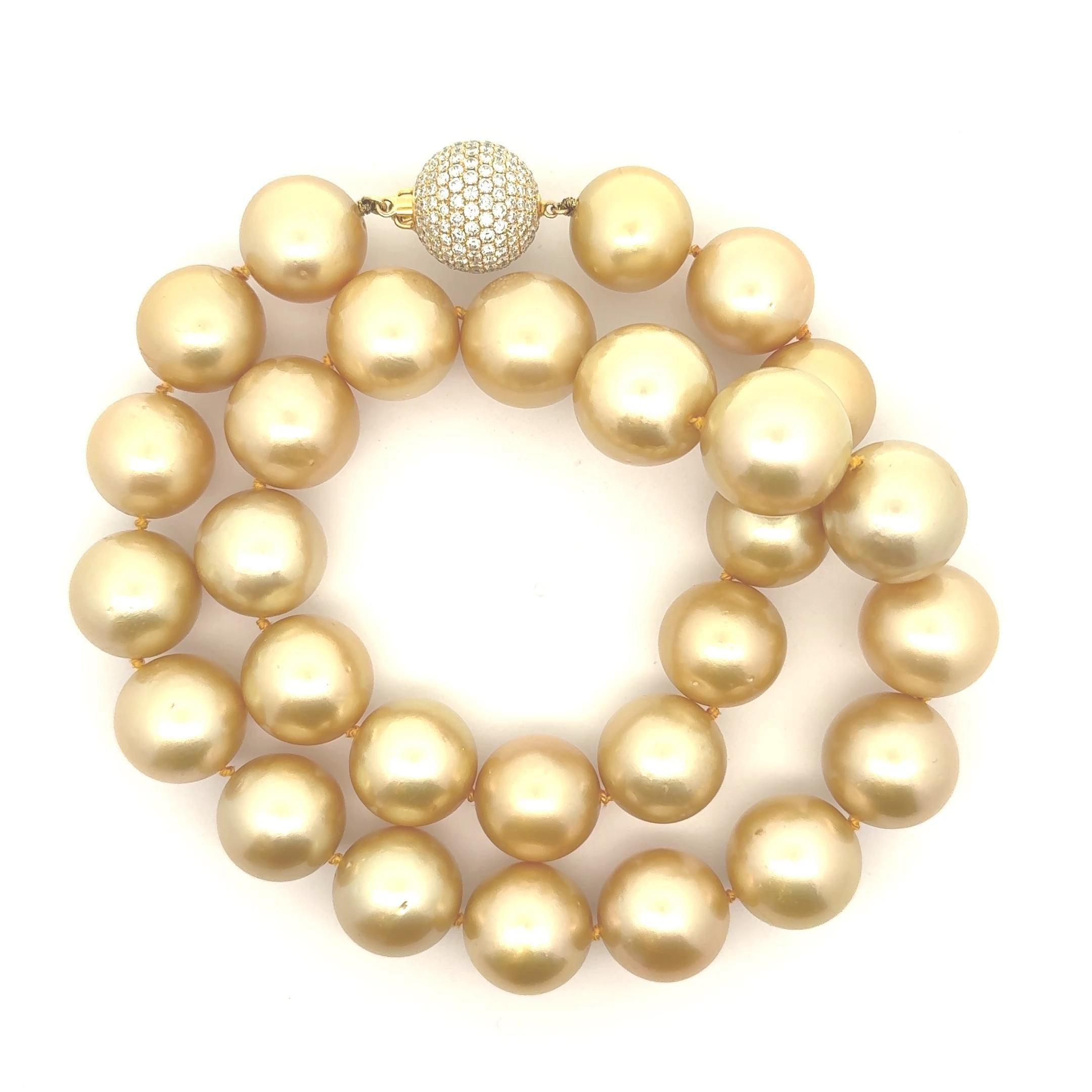 This necklace features lustrous South Sea pearls, each with a rich gold hue, each measuring a large and impressive 15-17mm. The pearls are complemented by round white diamonds totaling 4 carats, adding a touch of brilliance to the beautiful gold