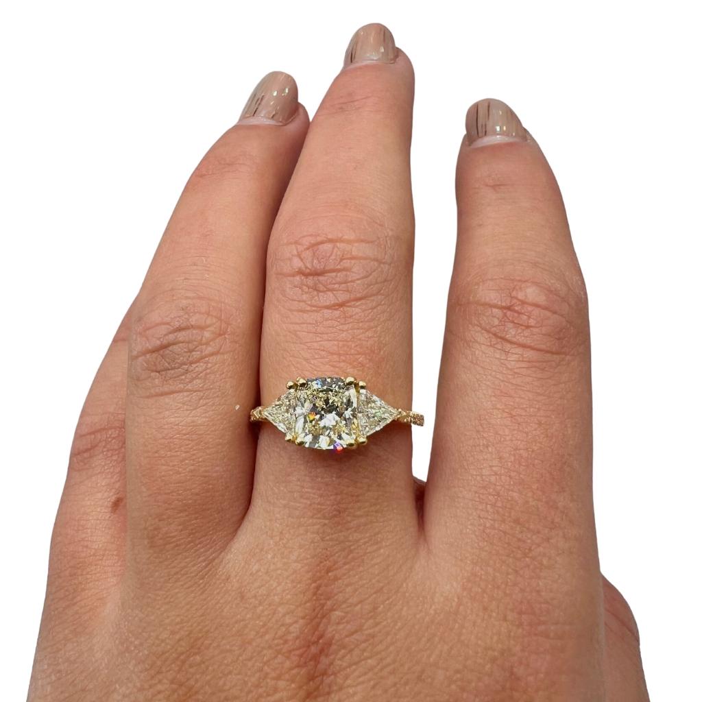 A stunning 1.51 carat rectangular cushion natural diamond ring set in 18K yellow gold. The center diamond is certified by IGI (certificate number 10J2182323) with a color of G-H, clarity of VS1, and cut grade of VG. The ring is further adorned with