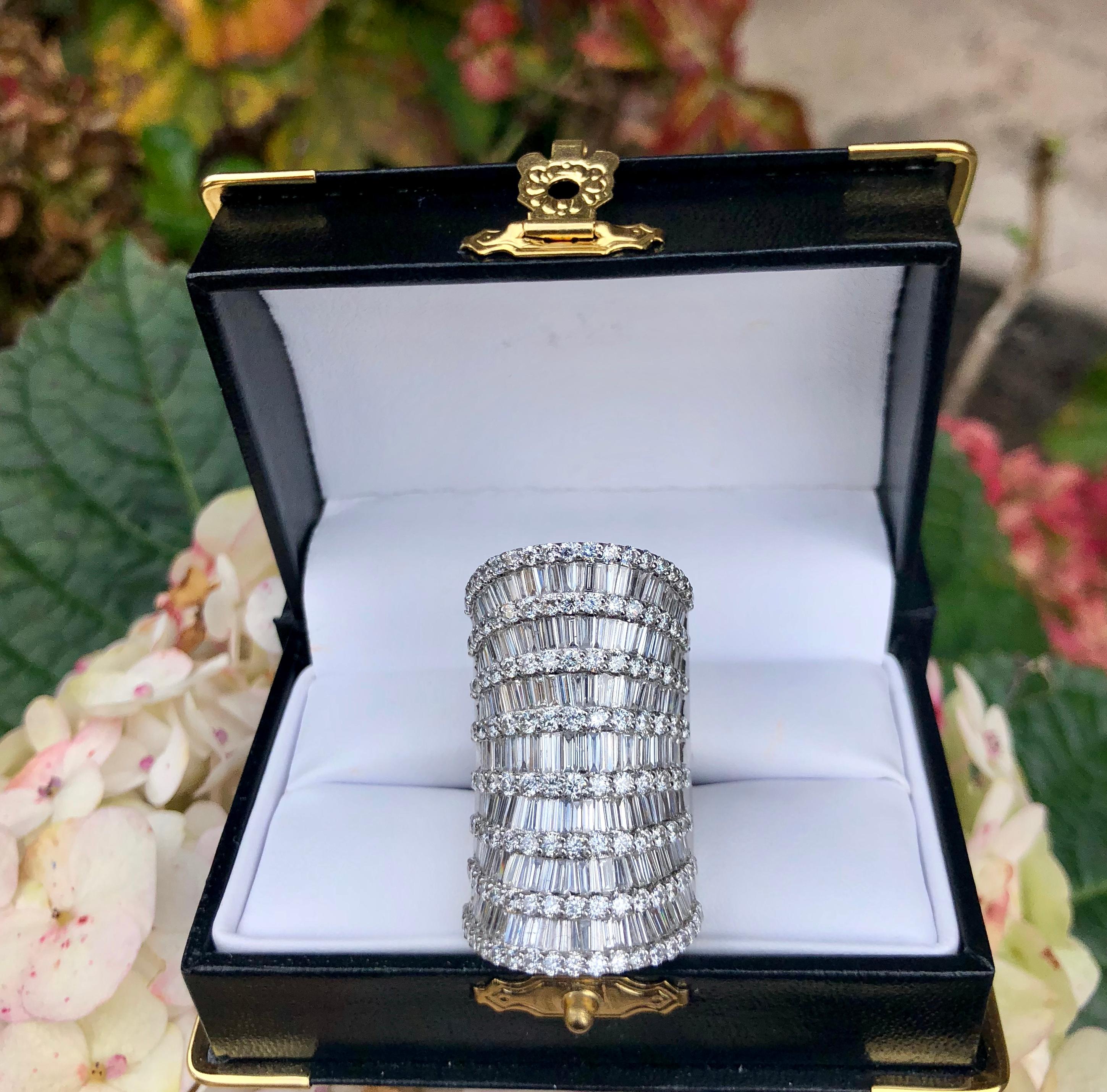 Incredibly sparkly 18 karat white gold cocktail ring features 7 rows of baguette diamonds, separated by 8 rows of prong set round brilliant diamonds.  This is a magnificent ring.  It is very smooth and low profile, and is shaped to fit very