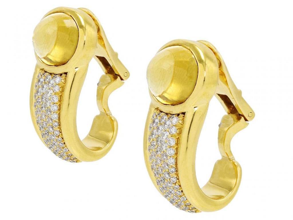 Beautiful high quality half hoop earrings are bezel set with a gorgeous oval cabachon citrine above a sparkling panel of pave diamonds, all framed in 18k yellow gold.  The citrines total 14 carats and the 122 brilliant cut diamonds weigh a total of