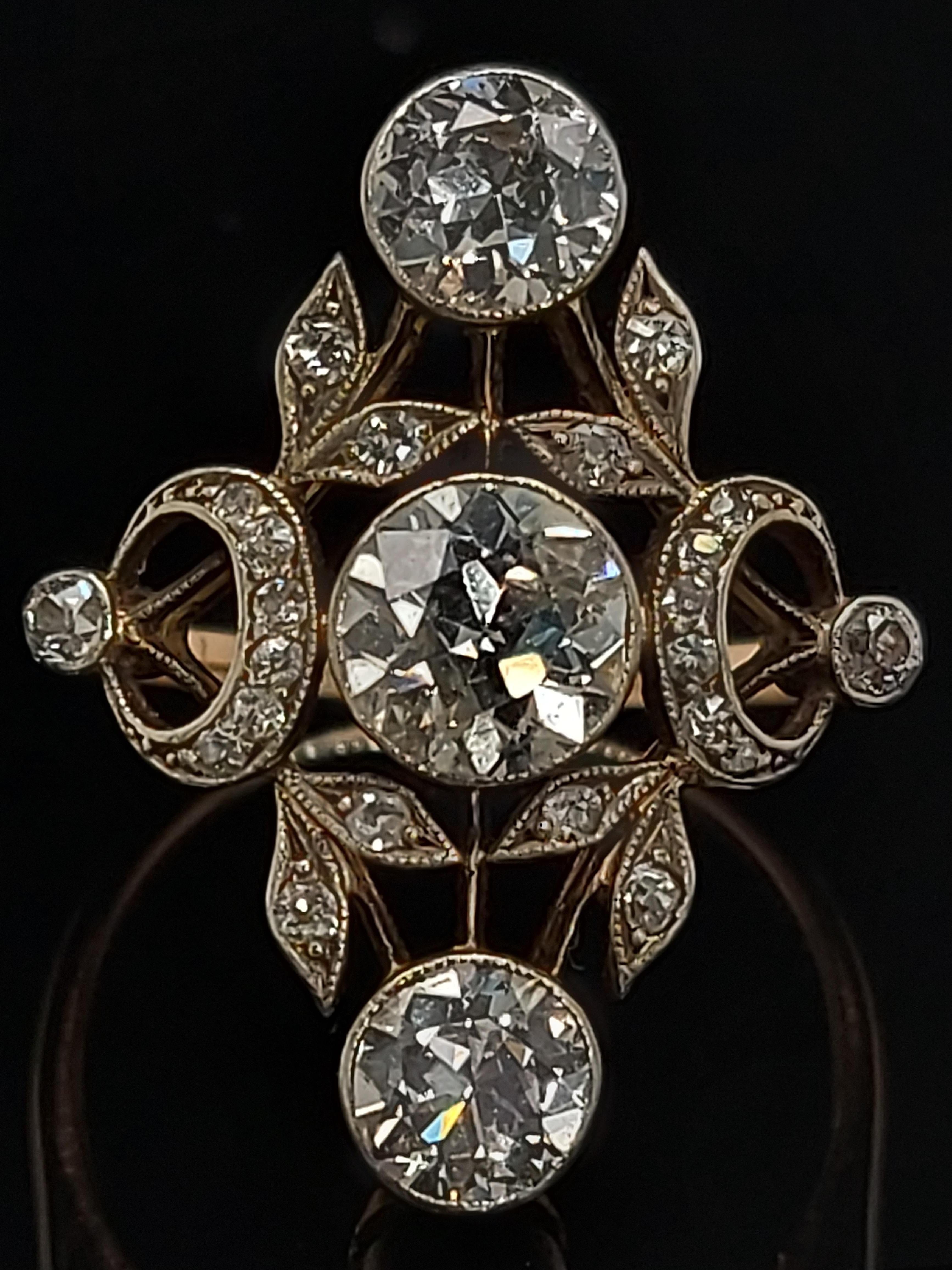 Stunning 18 kt Gold & Silver Ring With Diamonds from the 1900's ,Trilogy

Diamonds: 25 diamonds ,3 Big Old Cut Diamonds 2° of Ca. 0.7 each and center Ca. 1 Ct.

Material: 18 kt gold and silver

Dimensions: Top of ring 20 mm x 24.6 mm

Ring size: