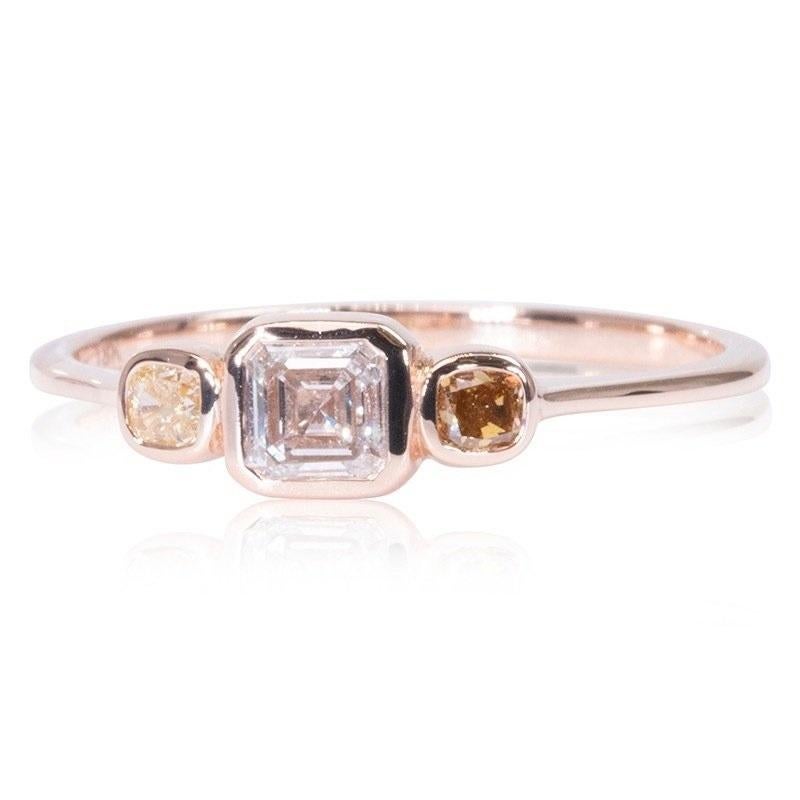 Stunning 3 stone ring made from 18k rose gold with 0.57 total carat of asscher cut diamond and fancy cushion shape diamonds. This ring comes with an AIG certificate and a fancy box.

-1 diamond main stone of 0.37 ct.
cut: asscher 
color: E
clarity: