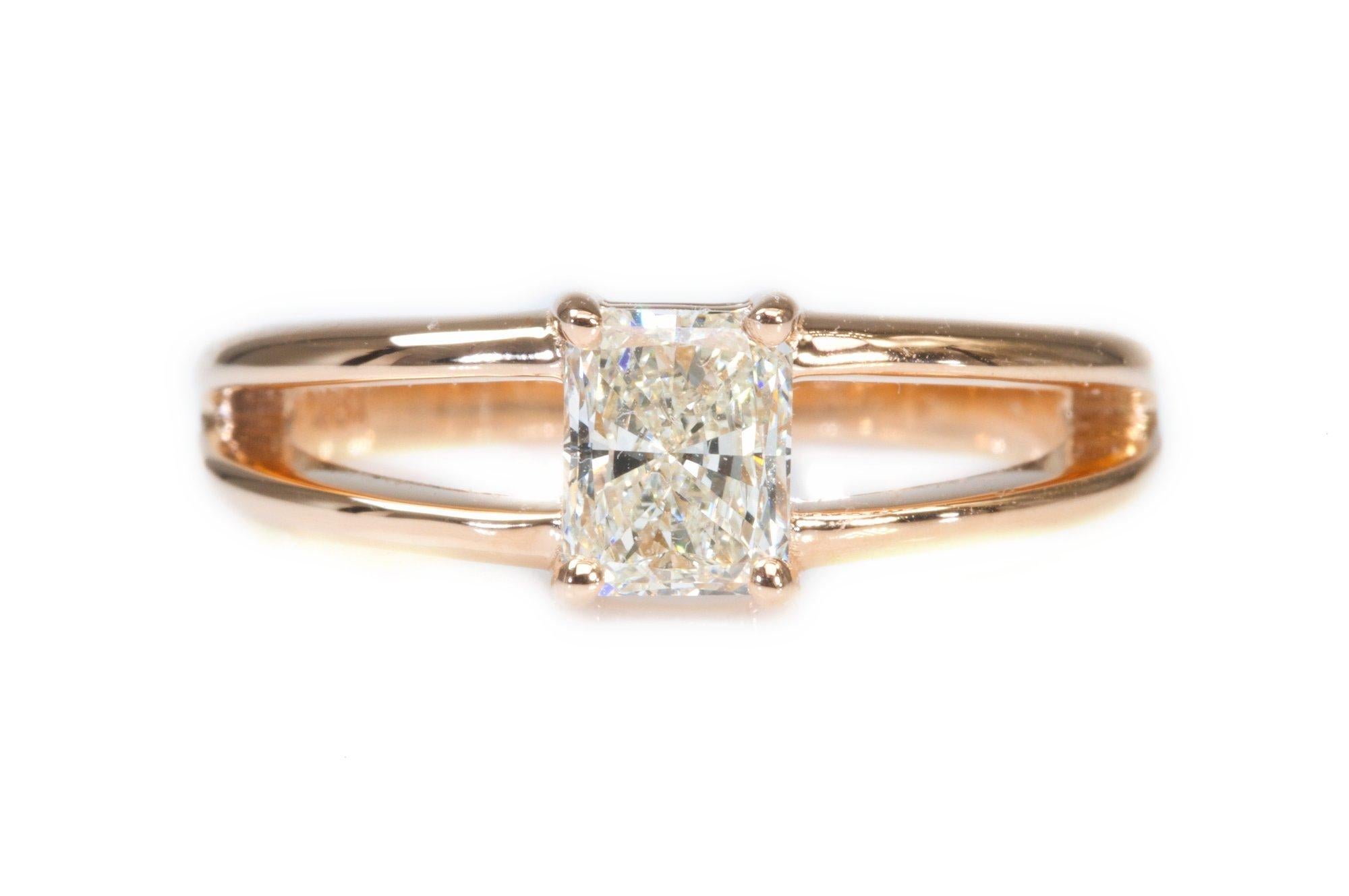 A stunning classic solitaire ring with a dazzling 0.50 carat radiant cut natural diamond in I VS1 mounted in a spilt shank setting made of 18K white gold with a high quality polish. The main stone is engraved with a laser inscription and has a GIA