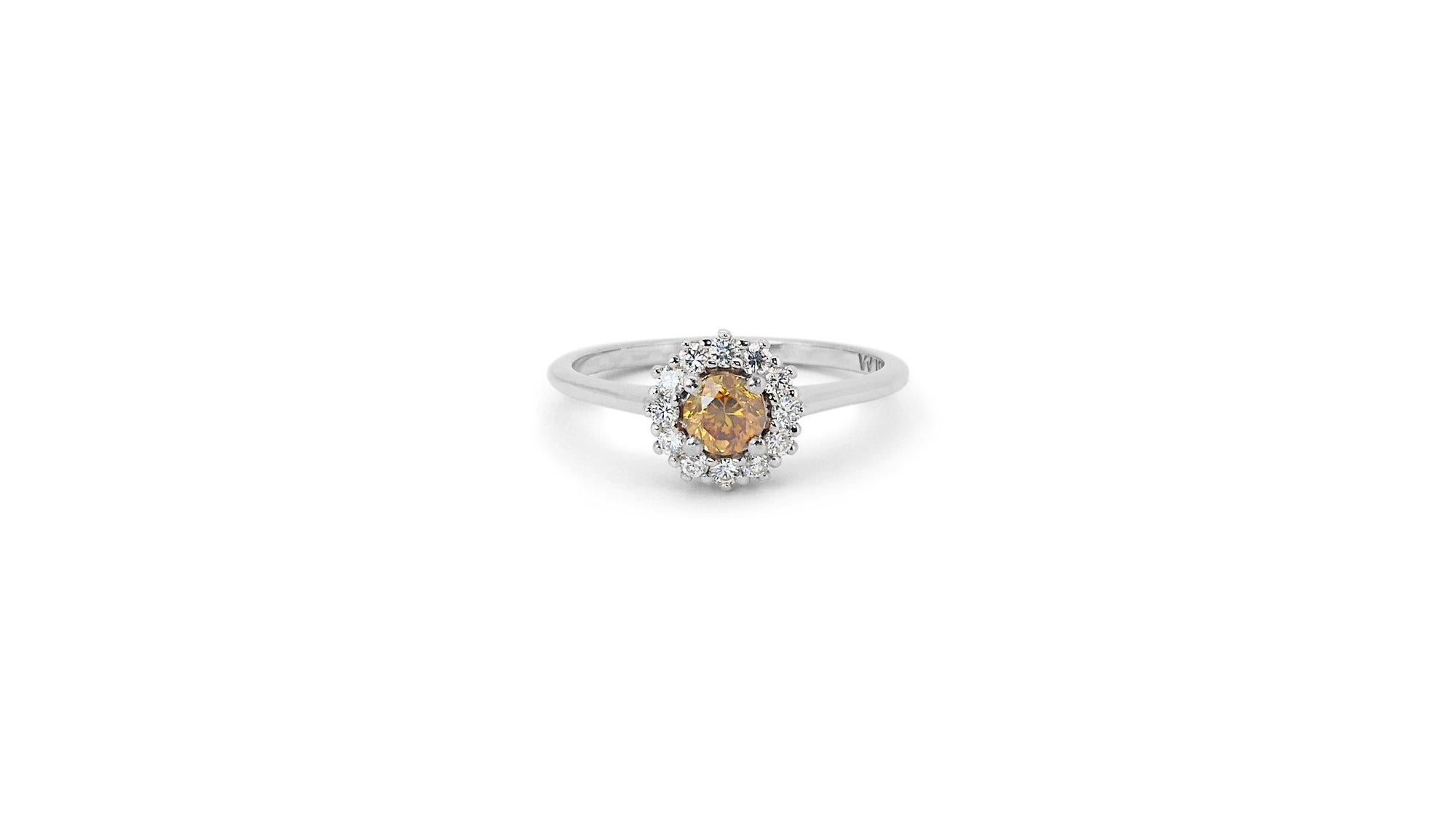 A gorgeous Halo Ring with a dazzling 0.4-carat Round Brilliant natural diamond. It has 0.25 carat of side diamonds which add more to its elegance. The jewelry is made of 18K White with a high-quality polish. It comes with an AIG certificate and a