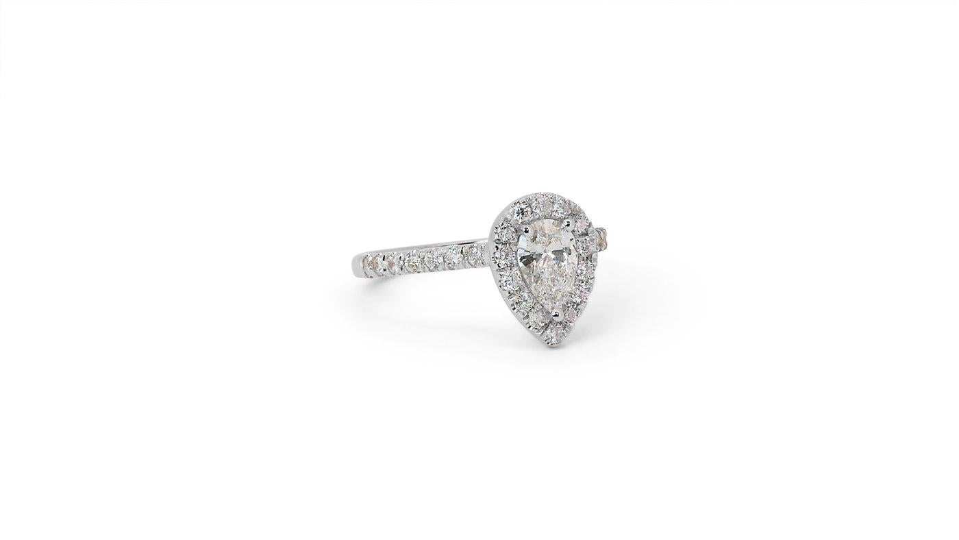 A stunning halo ring with a dazzling 0.56-carat pear natural diamond. It has 0.42 carats of side diamonds which add more to its elegance. The jewelry is made of 18K White Gold with a high-quality polish. It comes with an IGI certificate and a fancy