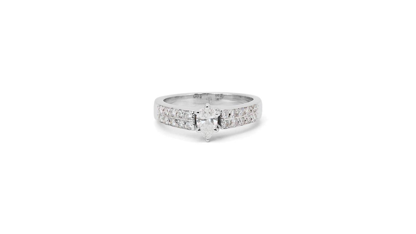 A stunning pave ring with a dazzling 0.45 carat pear natural diamond. It has 0.35 carat of side diamonds which add more to its elegance. The jewelry is made of 18K White Gold with a high quality polish. It comes with AIG certificate and a fancy