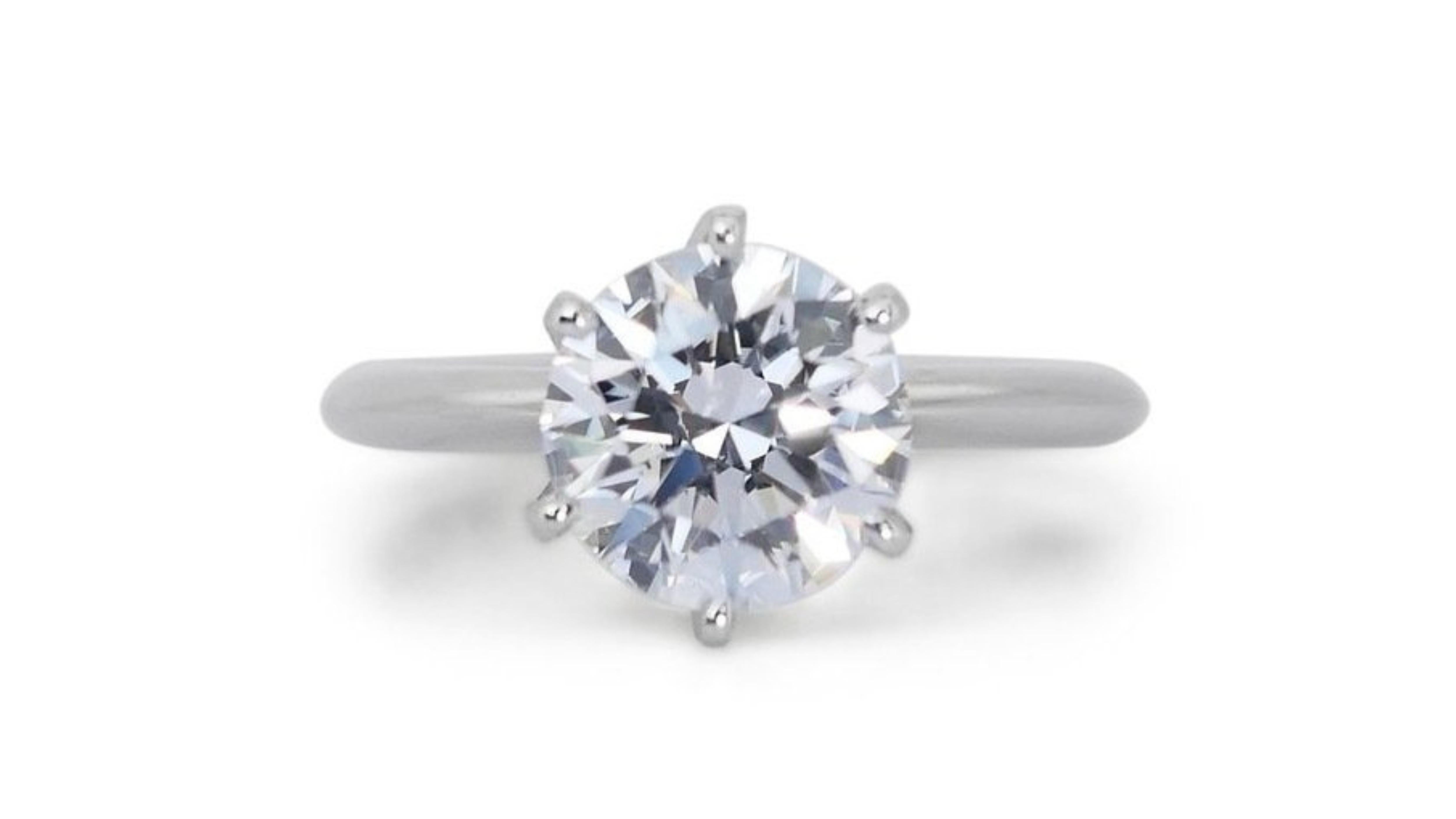 This exquisite solitaire ring showcases a dazzling 2.15 carat round brilliant diamond. The diamond is F color and VS2 clarity, with an excellent cut grade, ensuring maximum brilliance and sparkle. The setting is made of platinum, a durable and
