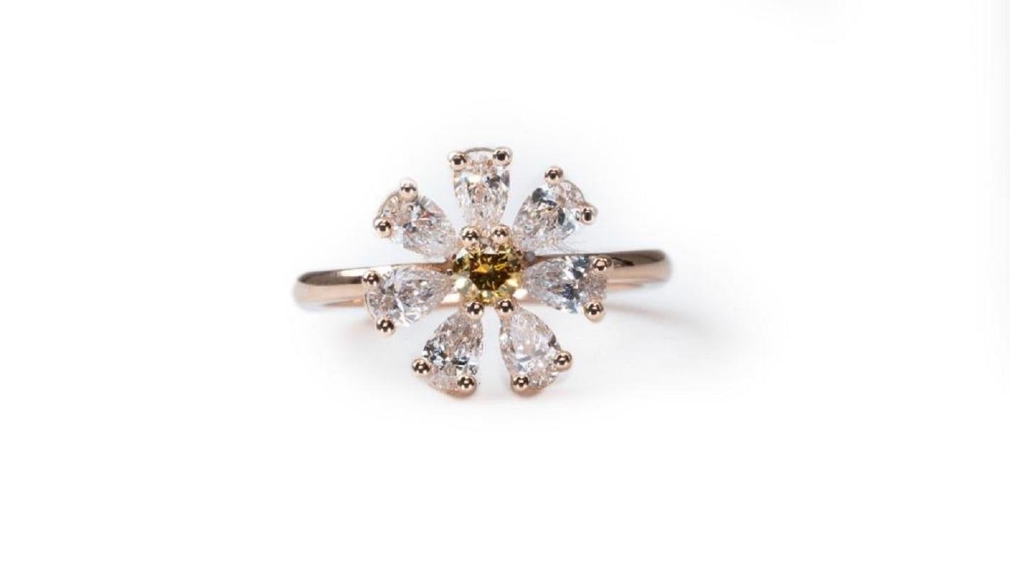 One of a kind Flower style Ring with 1.08 carat of fine and natural diamonds with a center of Fancy vivid brownish yellow natural Diamond with 7 natural pear shape diamonds and made from 18k rose gold with AIG certificate.

Main Stone:
1 diamond
