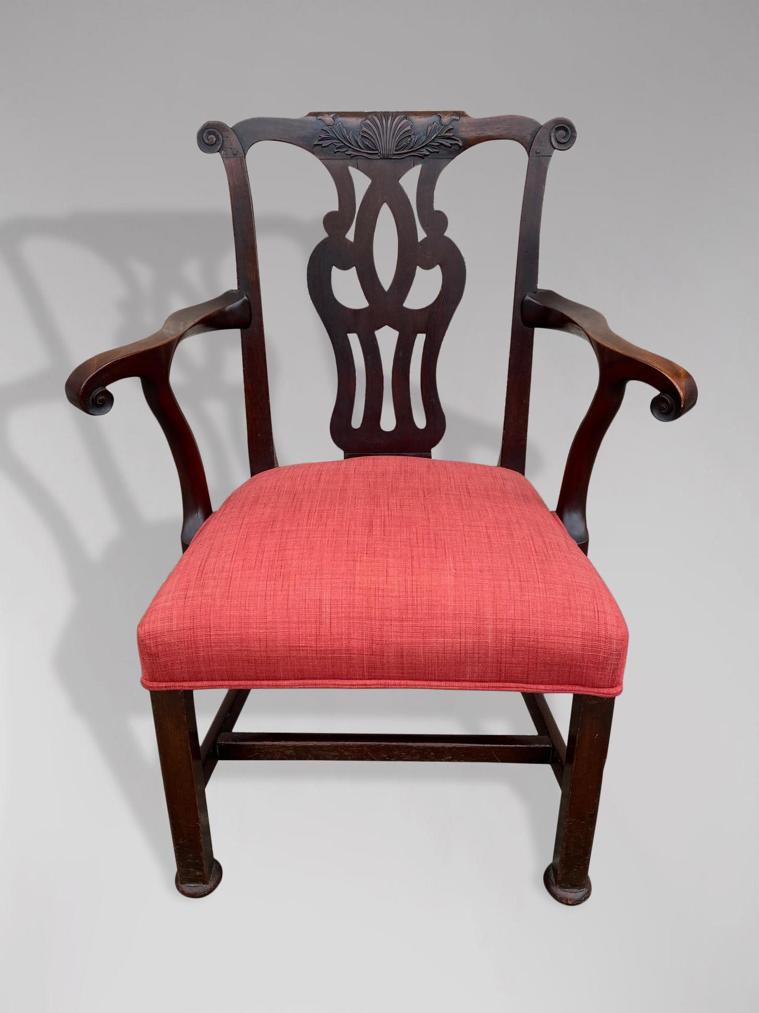 A late 18th century, George III period Chippendale Cuban mahogany armchair, the shaped crest rail with carved 'c' scroll ends above the wide, carved, pierced splat and bold out scrolling arms. The padded upholstered seat raised on moulded