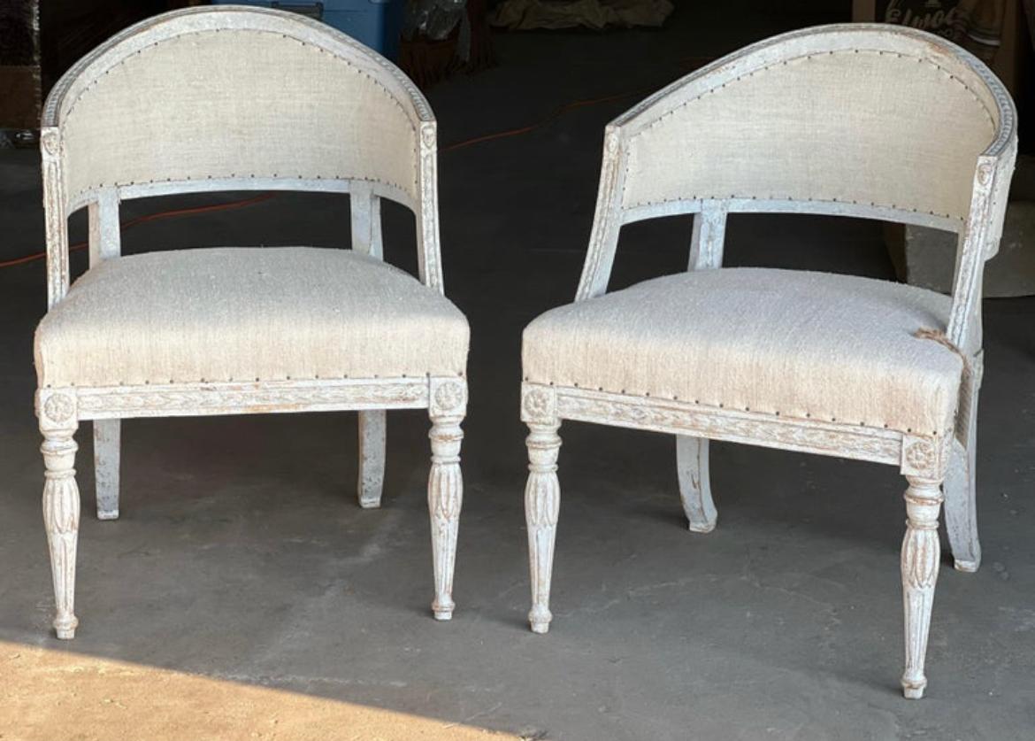A gorgeous and unique pair of late 18th century Swedish barrel backs from the Gustavian period that have been dry scrapped and then had a recent paint touch up with grays and white hues to the wooden details. fine details include: unique and rare
