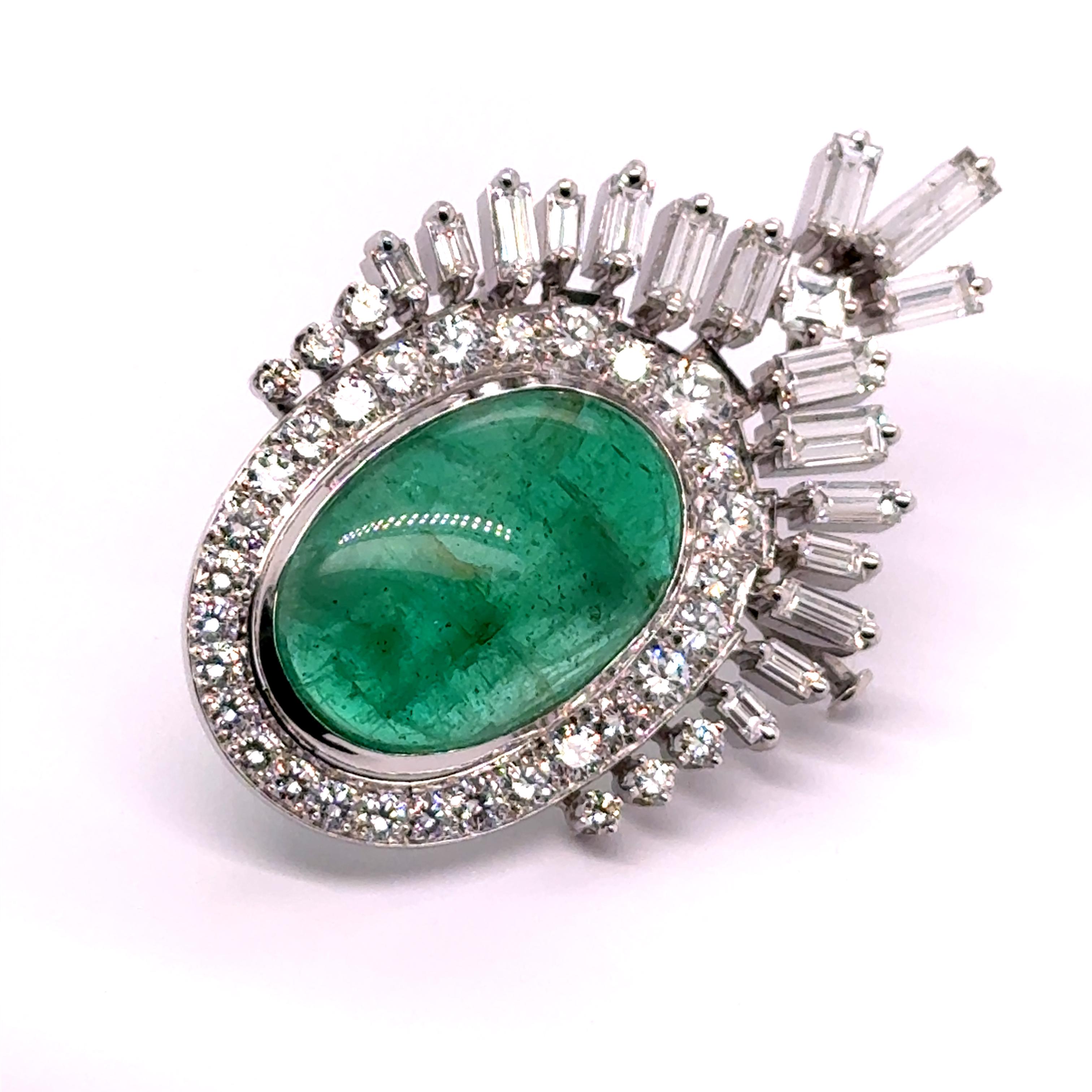 Enveloped in a luminous green glow, a captivating 19.00-carat cabochon-cut emerald forms the heart of this exquisite brooch.

Set in Platinum 950, its brilliance is enhanced by a halo of 34 brilliant-cut diamonds, totaling 2.40 carats, while 18