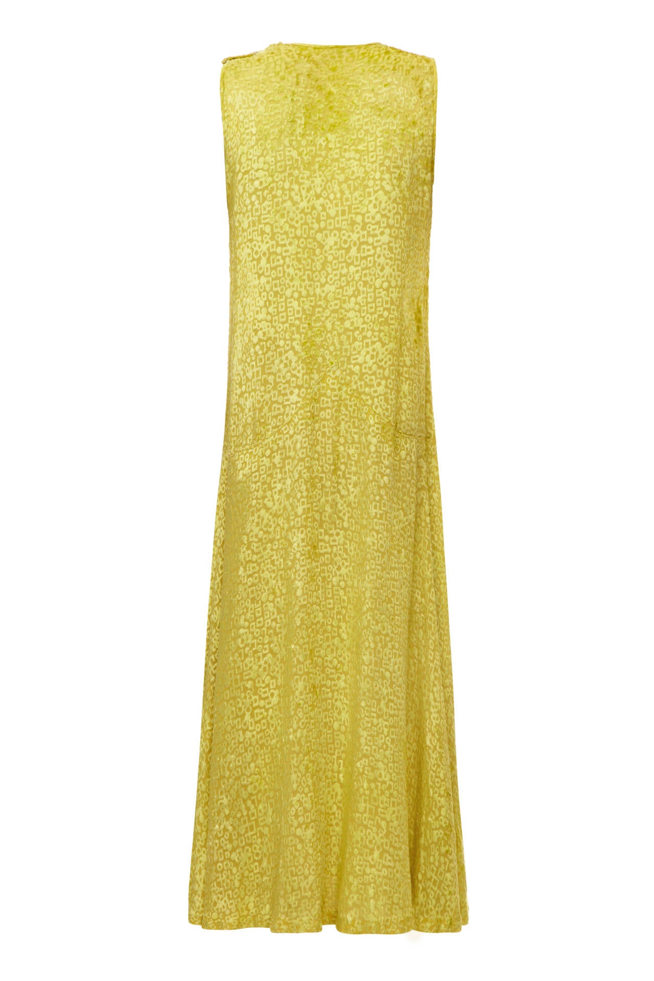 This gorgeous soft golden yellow velvet panne silk flapper dress is a really lovely example of 1920s clothing and is in superb vintage condition. The velvet of the dress has an intricate abstract design that has been meticulously burnt into the