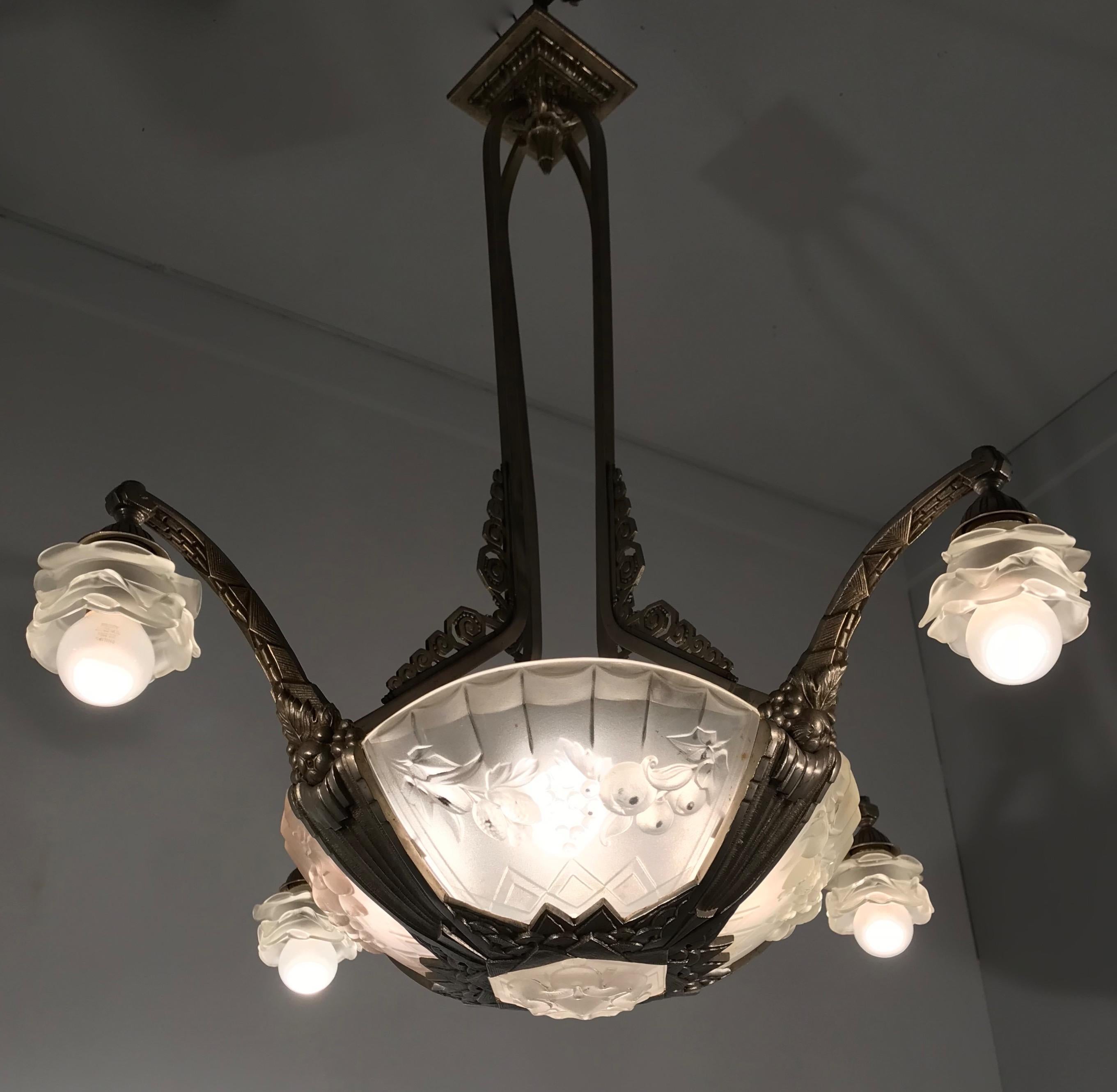 Top quality and practical size Art Deco eight-light pendant.

This highly stylish Art Deco light fixture was handcrafted in France in the 1930s. The nickel plated bronze actually makes it look like it is made of silver. This silver look makes the