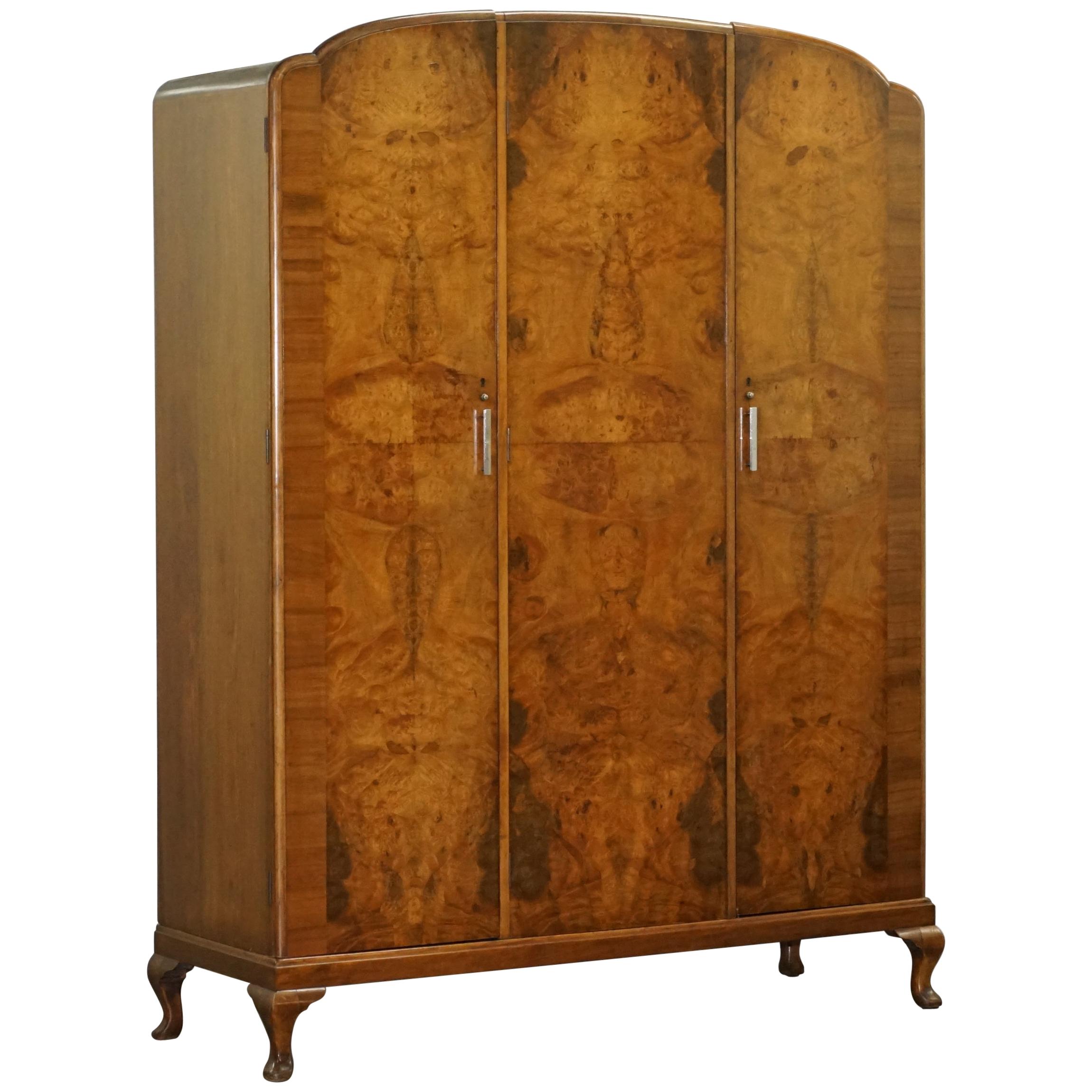 We are delighted to offer for sale this stunning burr walnut Waring & Gillow 1932 triple bank wardrobe with built in mirror

This is a very good looking well made and decorative piece, the door panels have rich warm burr walnut which glows in the