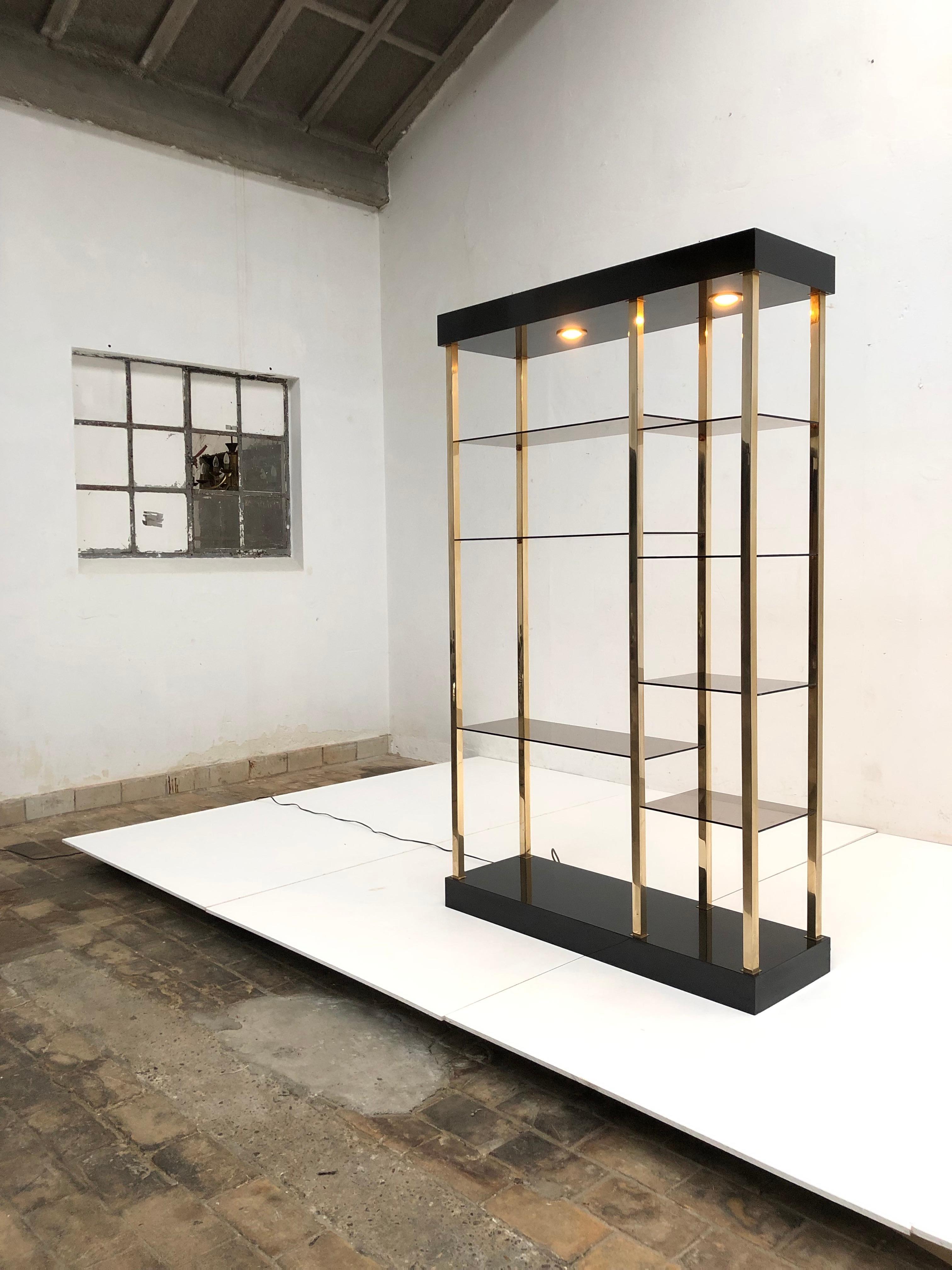 Luxurious looking Romeo Rega style shelving/display in brass and glass and black formica.

This shelving can be placed against a wall but also be used as a room divider as all sides have been finished off nicely

Your showcase pieces can be