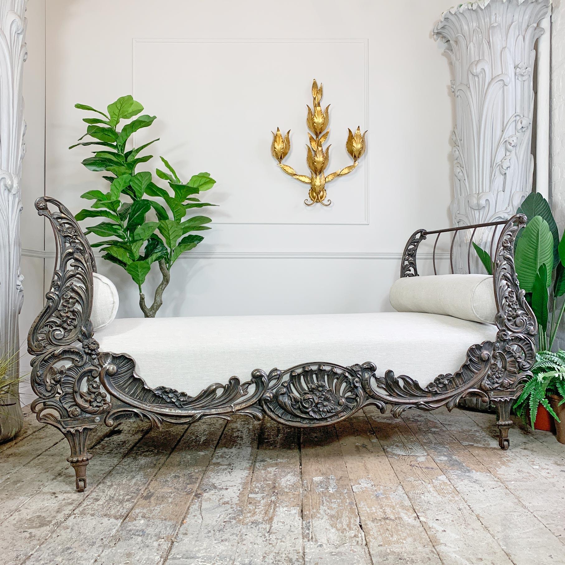 An absolutely gorgeous cast iron day bed, made in France circa 1890, the deeply cast floral design with acanthus leaves and scrolls, it exudes early French Nouveau influences.

The wooden framed cushioned bed base has been fully re-upholstered in a