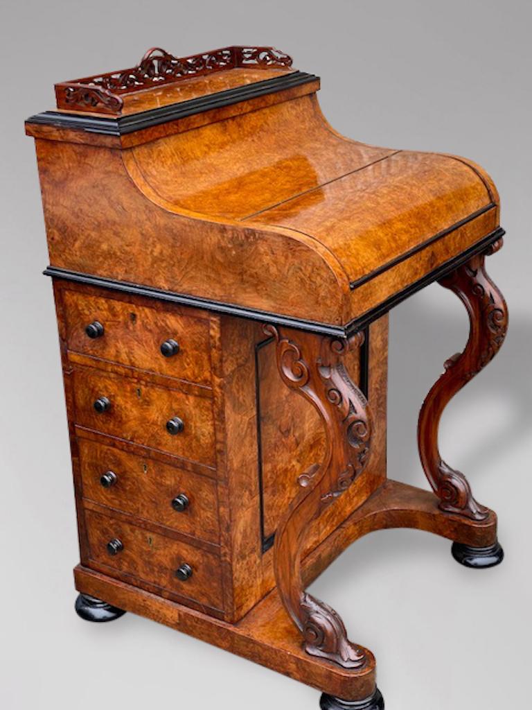 A mid 19th Century, Victorian period burr walnut and ebony moulding pop up davenport desk. The top with a very fine fretwork gallery above a slide out writing surface with the original tooled leather inset, with stationary storage underneath with a